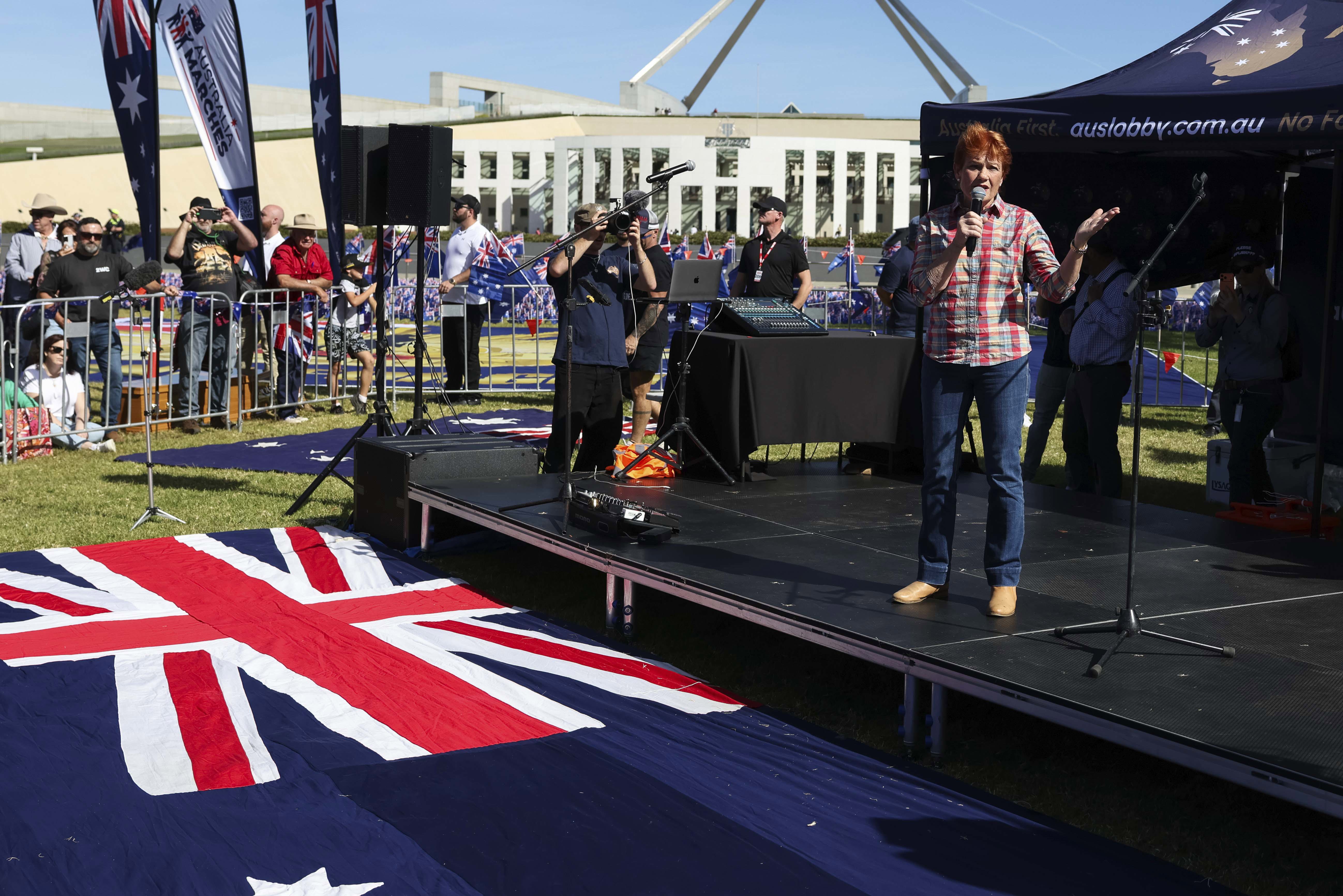 A protest in Canberra has called for an end of mass immigration to the country.Hundreds gathered on Parliament's lawn draped in the flag with One Nation leader Pauline Hanson leading the rally.