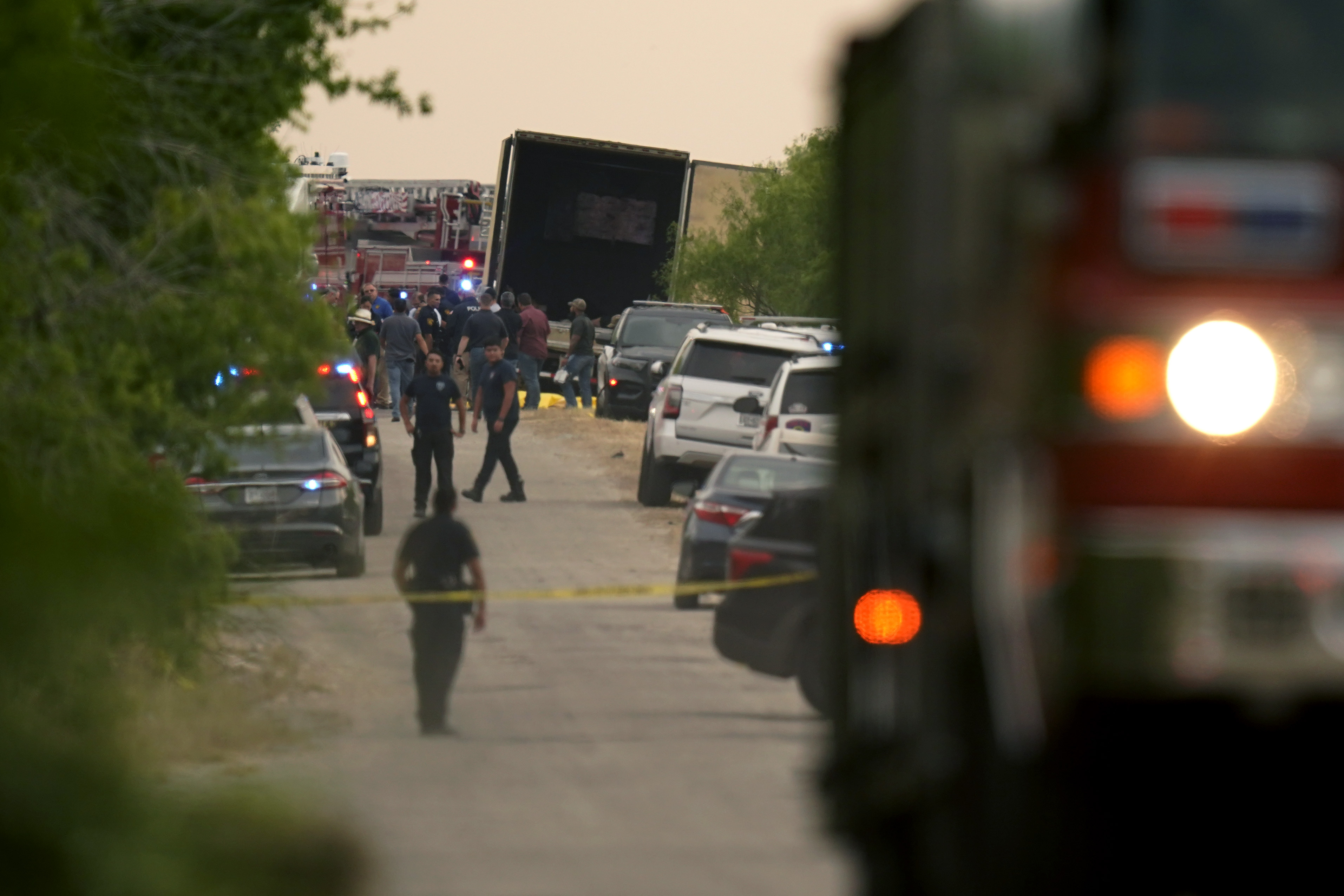 Body bags lie at the scene where a truck with multiple dead bodies was discovered in San Antonio.