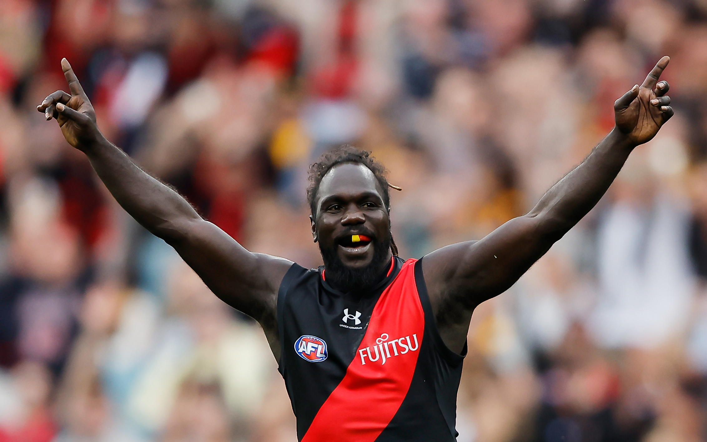 MELBOURNE, AUSTRALIA - MARCH 19: Anthony McDonald-Tipungwuti of the Bombers celebrates a goal during the 2023 AFL Round 01 match between the Hawthorn Hawks and the Essendon Bombers at the Melbourne Cricket Ground on March 19, 2023 in Melbourne, Australia. (Photo by Dylan Burns/AFL Photos)