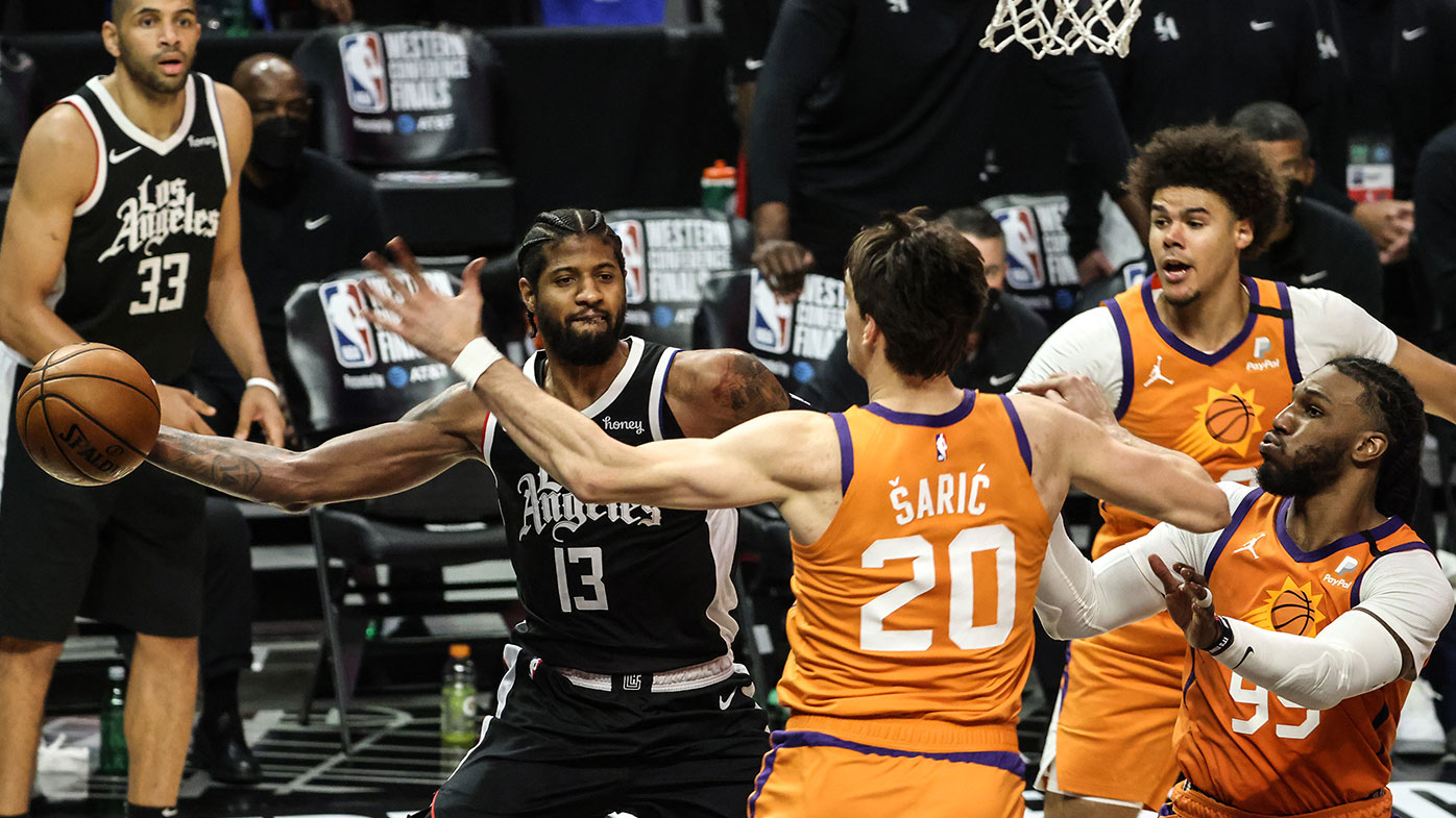 LA Clippers guard Paul George (13) passes to a teammate while three Suns defenders look on in the second half in Game three of the NBA Western Conference Finals at Staples Center. (Robert Gauthier/Los Angeles Times via Getty Images)