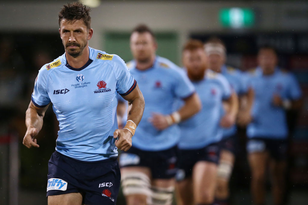 Jake Gordon of the Waratahs leads his team onto the field.