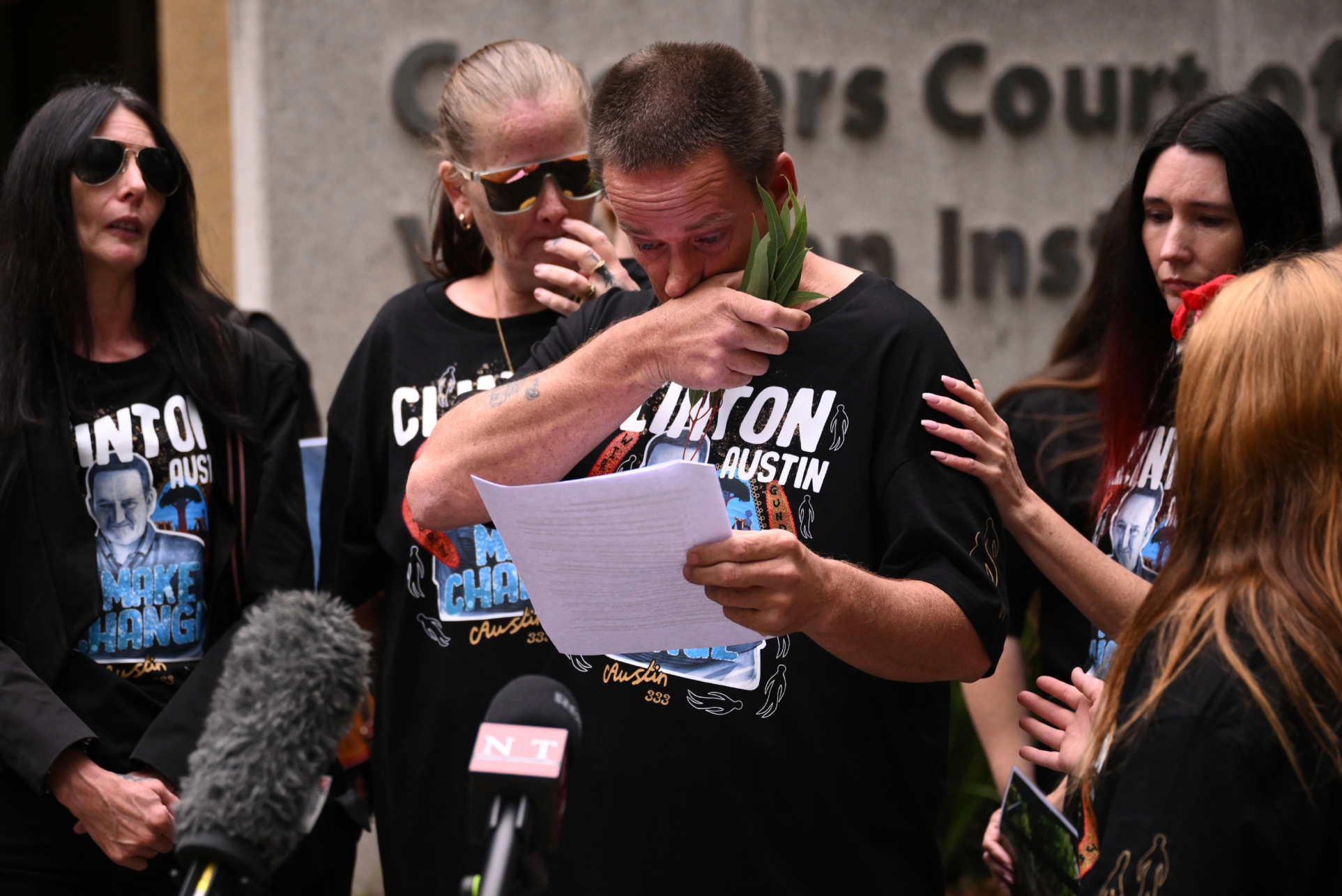 Shaun Austin (centre), twin brother of Clinton Austin reads a statement outside the inquest into death of Clinton Austin, at the Melbourne Coroners Court, in Melbourne, Monday, March 24, 2025. Clinton Austin, a 38-year-old Gunditjmara and Wiradjuri man died at Loddon Prison after being found unresponsive in his cell.  