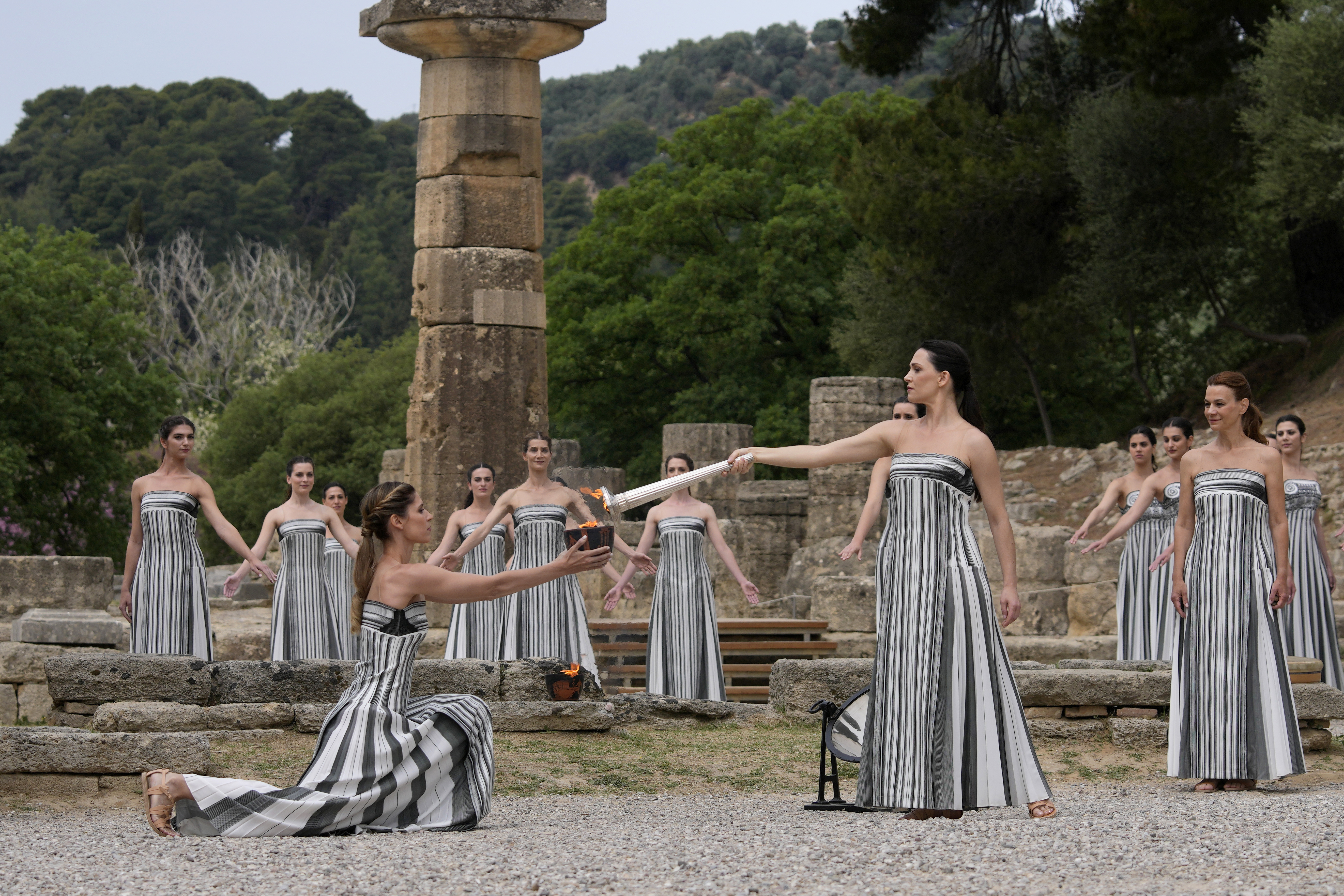 Performers take part in the official ceremony of the flame lighting for the Paris Olympics