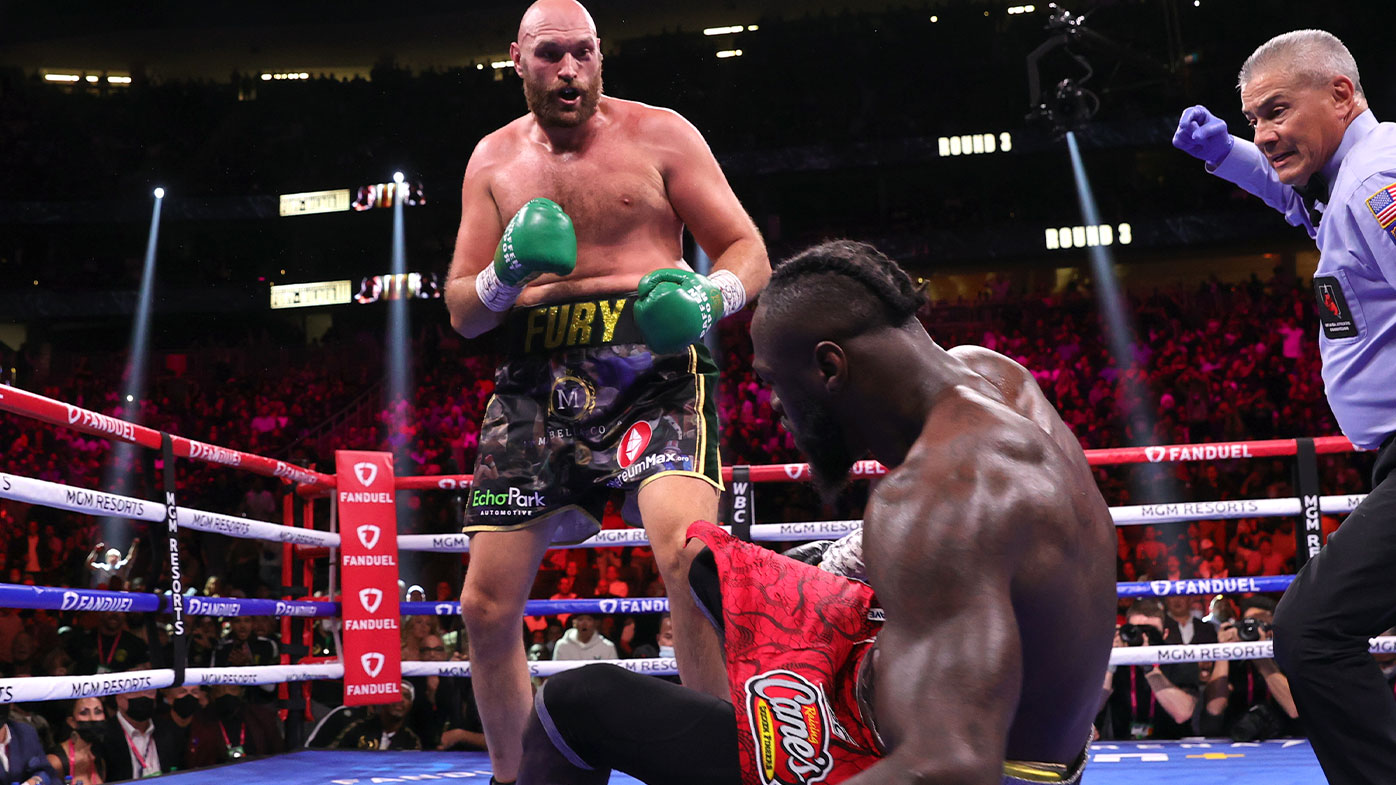  Tyson Fury (L) knocksdown Deontay Wilder (R) during their fight for the WBC heavyweight championship 