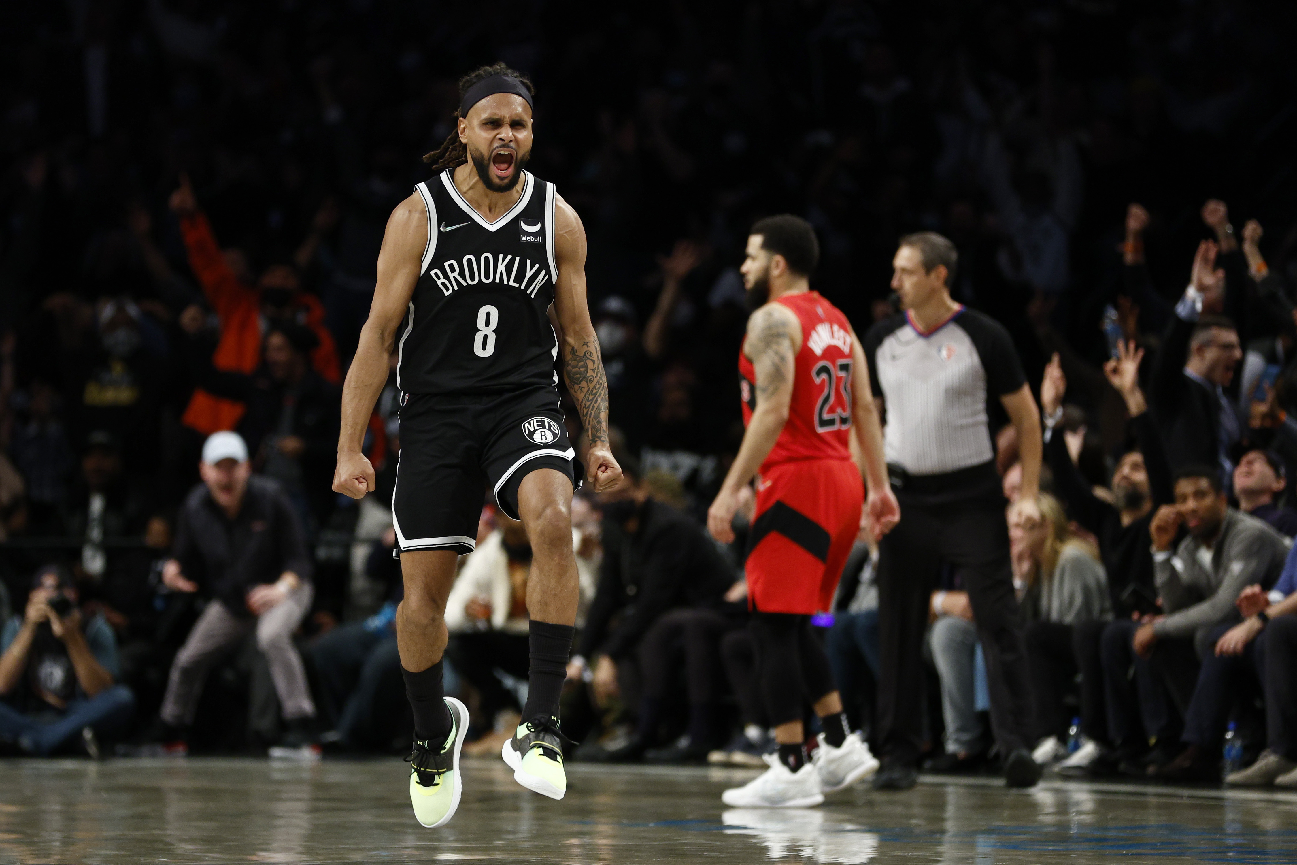 Patty Mills of the Brooklyn Nets reacts after making a three-pointer against the Toronto Raptors.