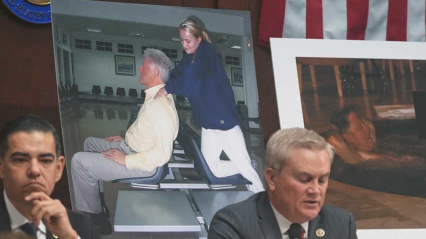 James Comer speaks in front of photos of Bill Clinton taken from the Epstein files.