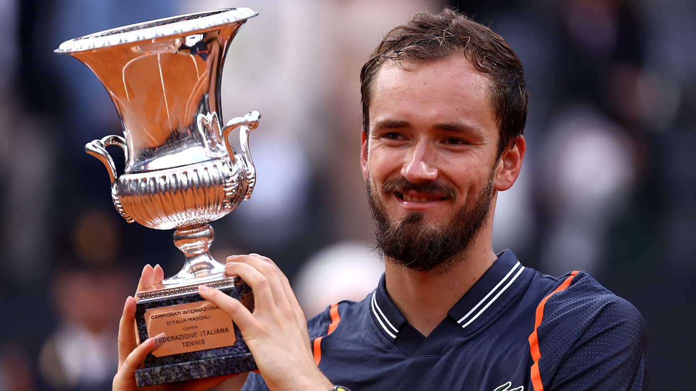 Daniil Medvedev celebrates with the Italian Open trophy after claiming the men's singles title over Holger Rune.