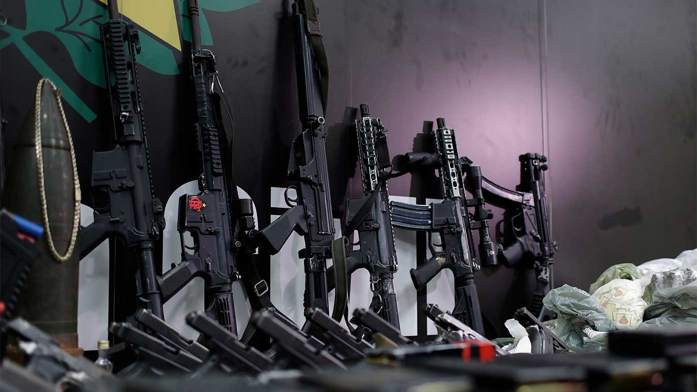 Weapons and drugs seized during a police raid are displayed for the press at city police headquarters in Rio de Janeiro, Brazil.