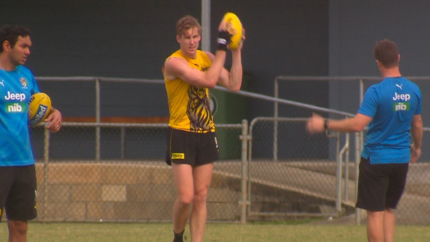 Tom Lynch marks the ball with his injured hand at training.