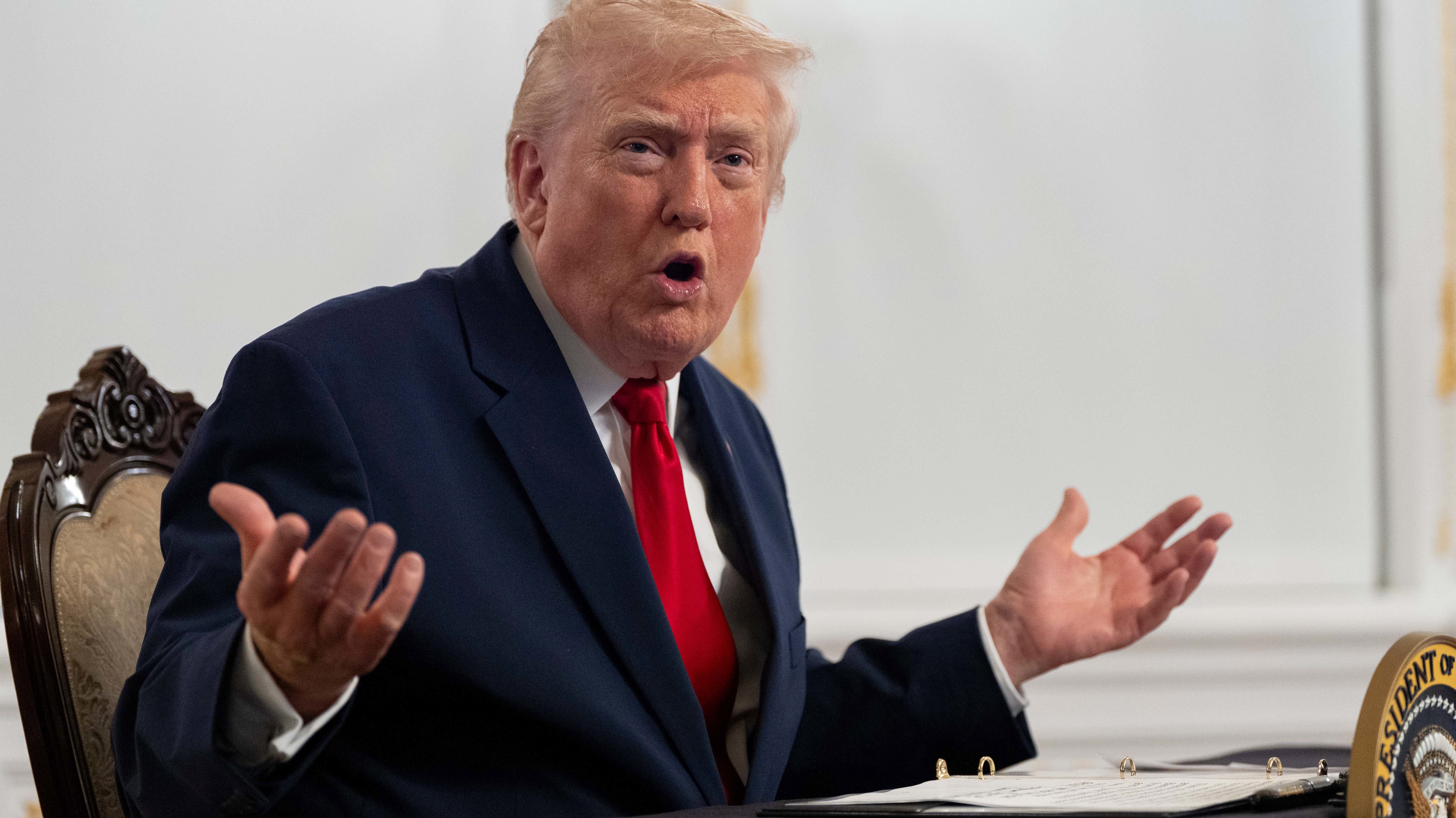 President Donald Trump speaks to reporters after speaking to troops via video from his Mar-a-Lago estate on Thanksgiving.