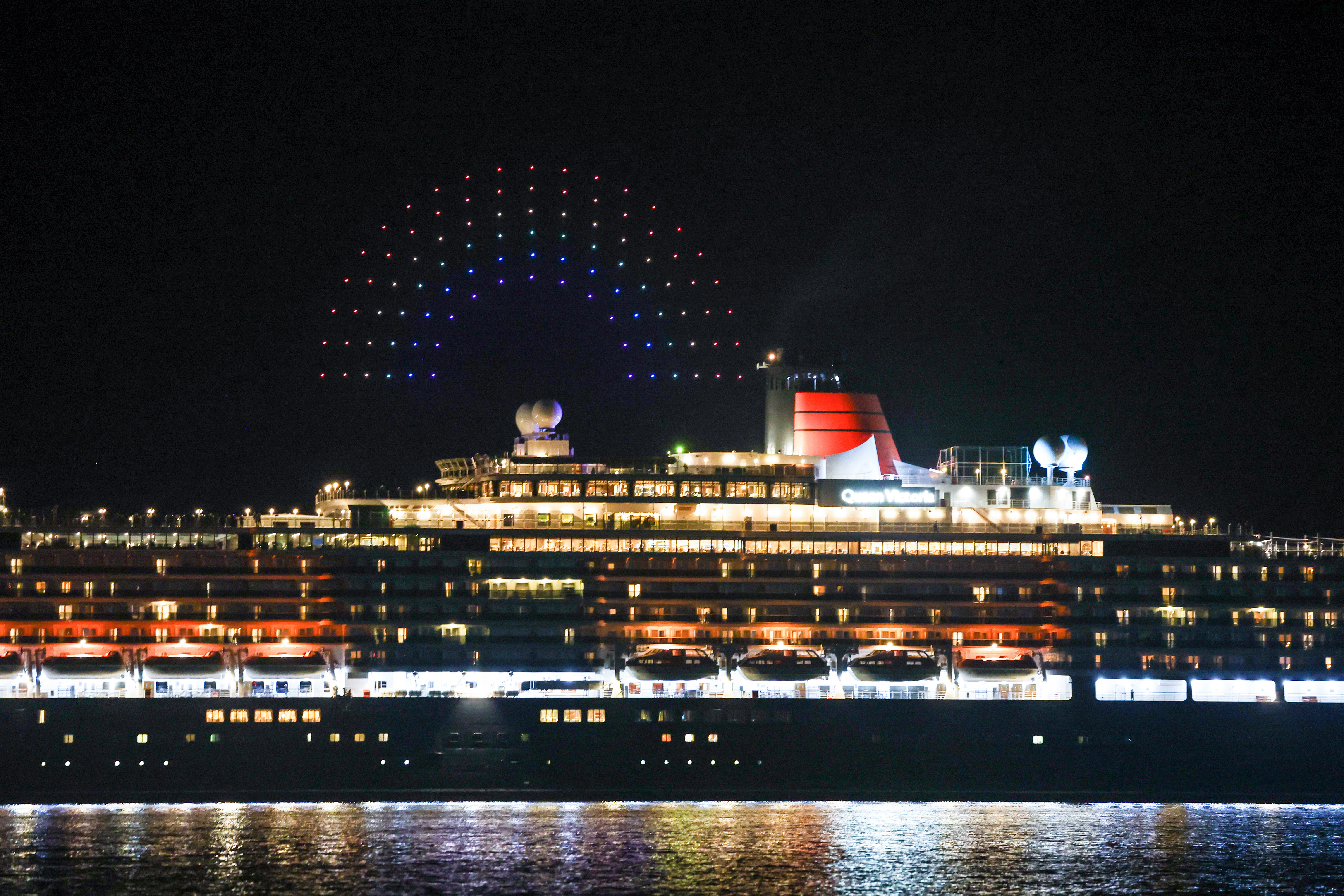 The Queen Victoria ship sails into Sydney Harbour with a special Pride-themed drone show.