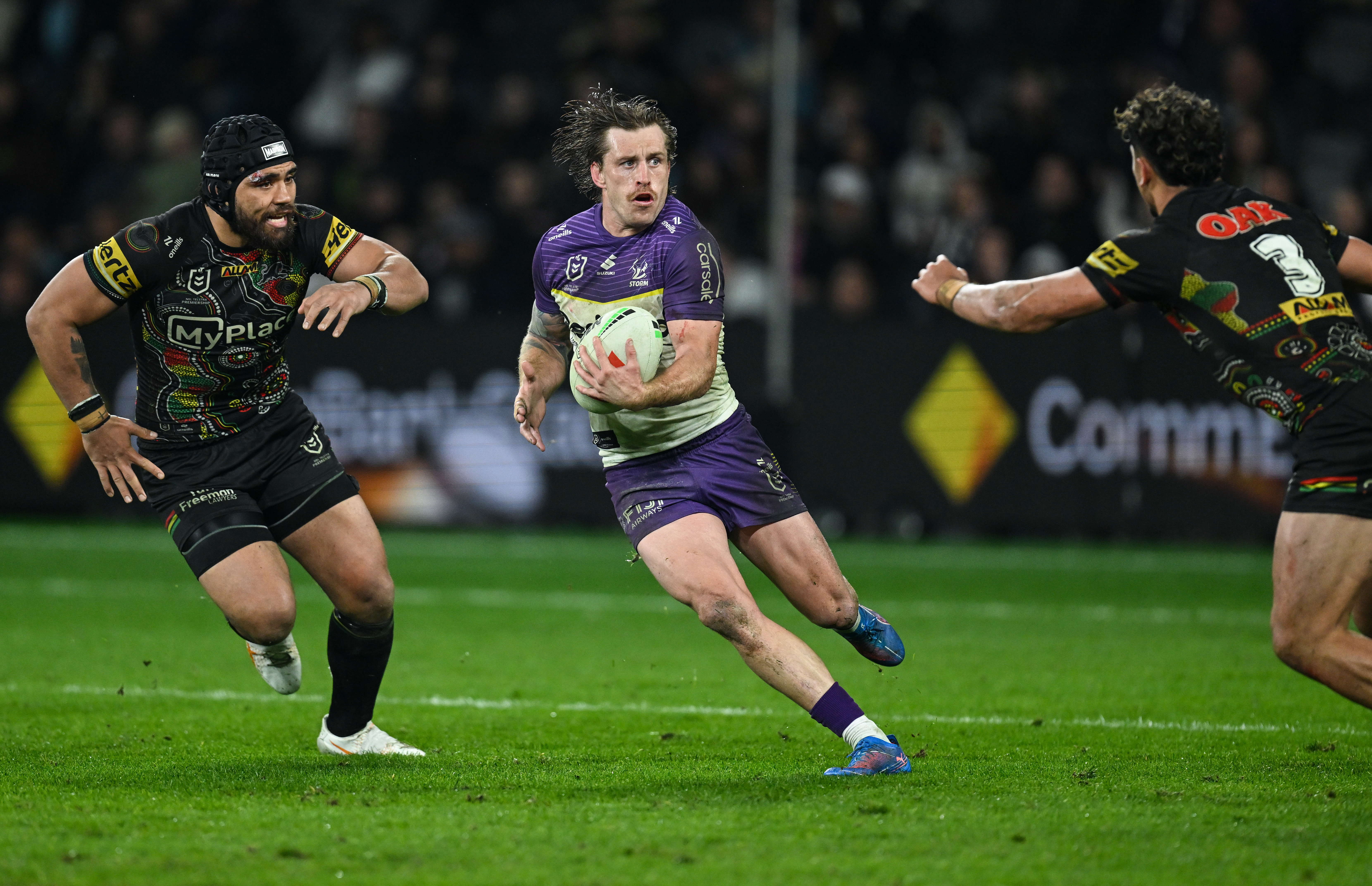Cameron Munster of the Melbourne Storm runs the ball.