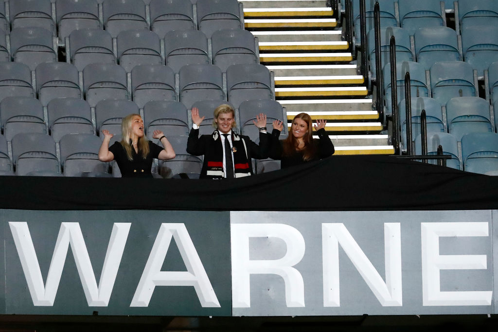 Brooke Warne, Jackson Warne and Summer Warne unveil the 'Shane Warne Stand' during the state memorial service.