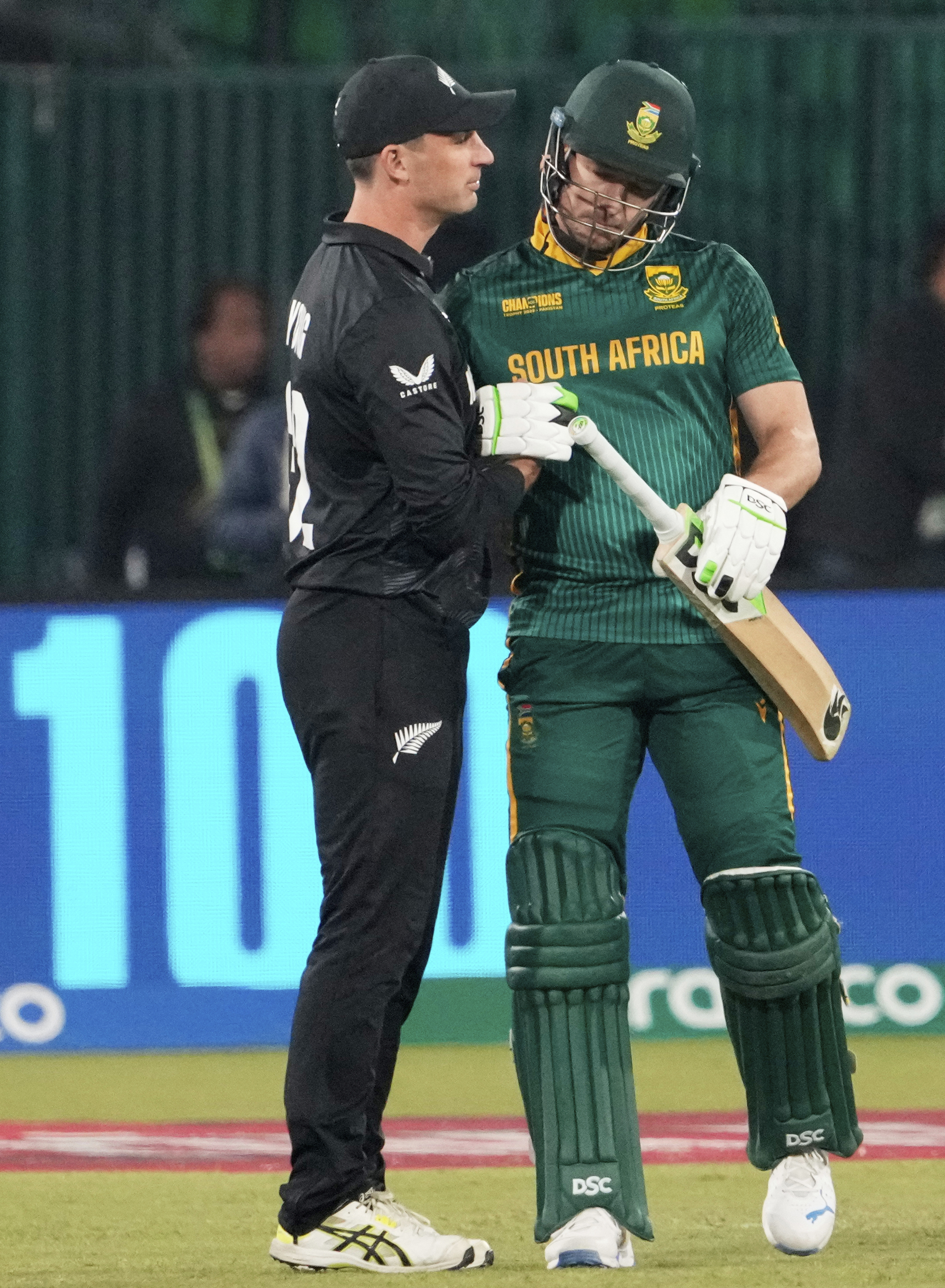 South Africa's David Miller, right, is congratulated by New Zealand's Will Young after completing his century.