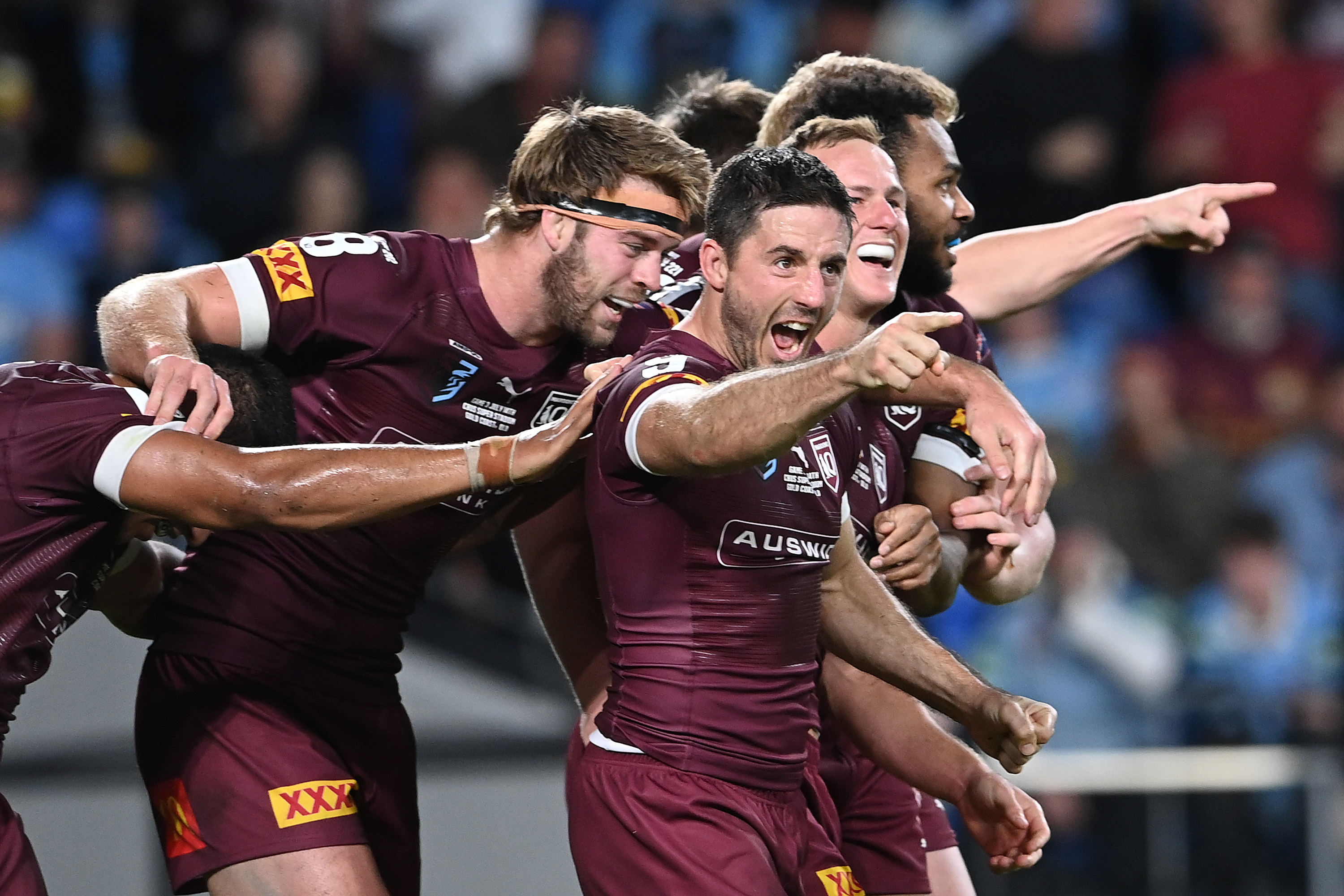 Ben Hunt celebrates with his Queensland Maroons teammates.