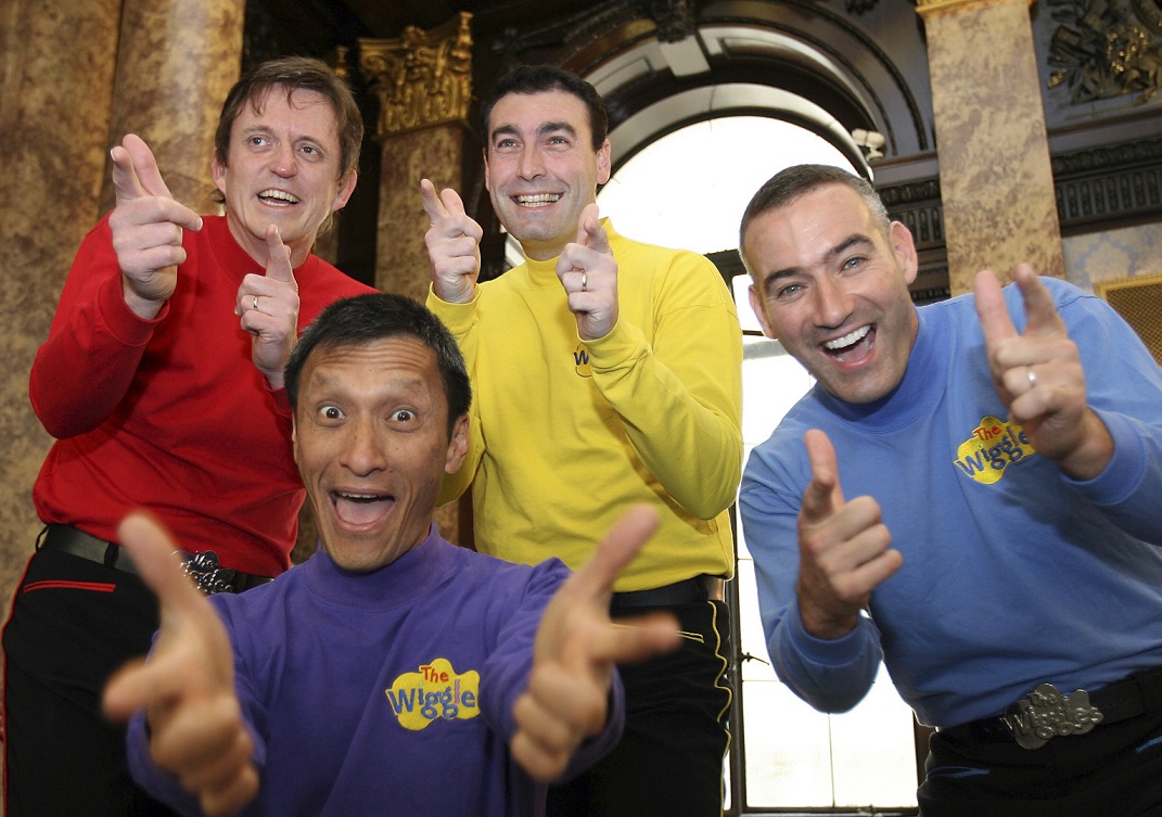 FILE - In this June 28, 2006 file photo, Australian children's entertainers The Wiggles, Murray Cook (Red Wiggle), Greg Page (Yellow Wiggle), Jeff Fatt (Purple Wiggle), and Anthony Field (Blue Wiggle) make a special appearance at the Australian High Commission in London at the start of their UK tour. Page, one of the original members of the popular Australian children's band has been hospitalized after collapsing during a wildfire relief concert.  Page fell as he left a stage in New South Wales 