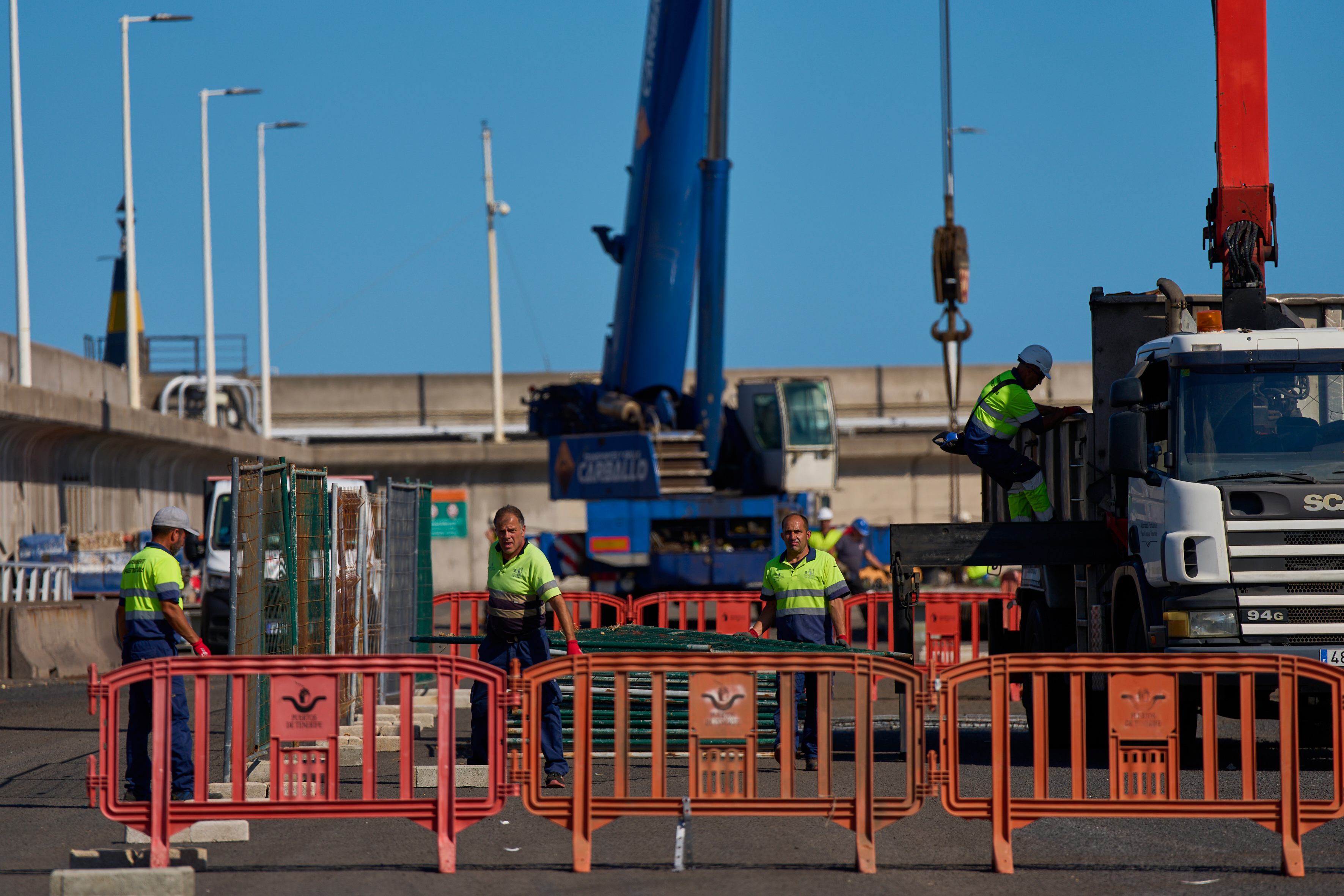 Workers prepare the area where passengers from the MV Hondius cruise ship are expected to arrive at the port of Granadilla in Tenerife, Canary Islands, Spain, Friday, May 8, 2026.