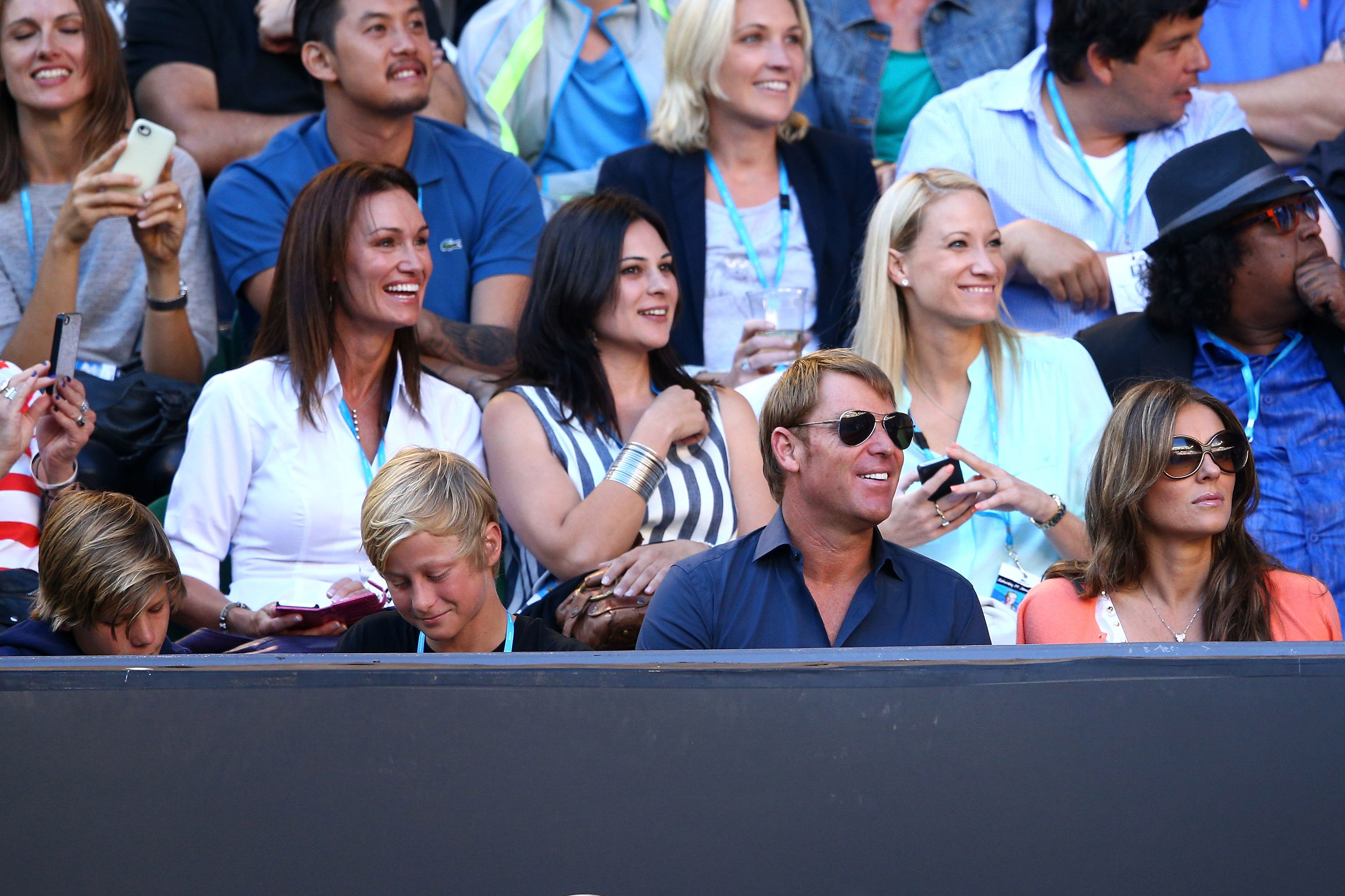 Shane Warne, Jackson Warne, Damien Hurley and Liz Hurley watch the tennis during day six of the 2013 Australian Open at Melbourne Park on January 19, 2013 in Melbourne, Australia