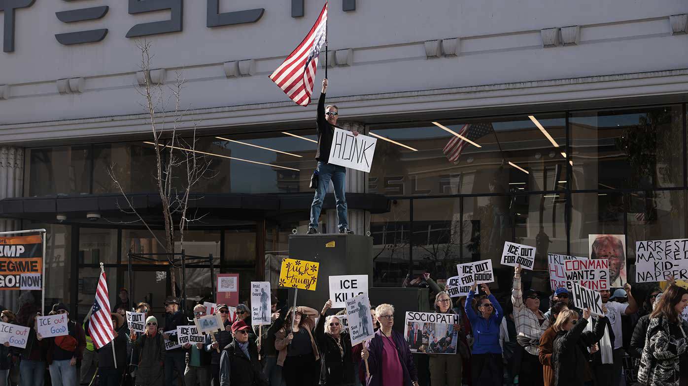 Protesters outside a Tesla dealership earlier this month.