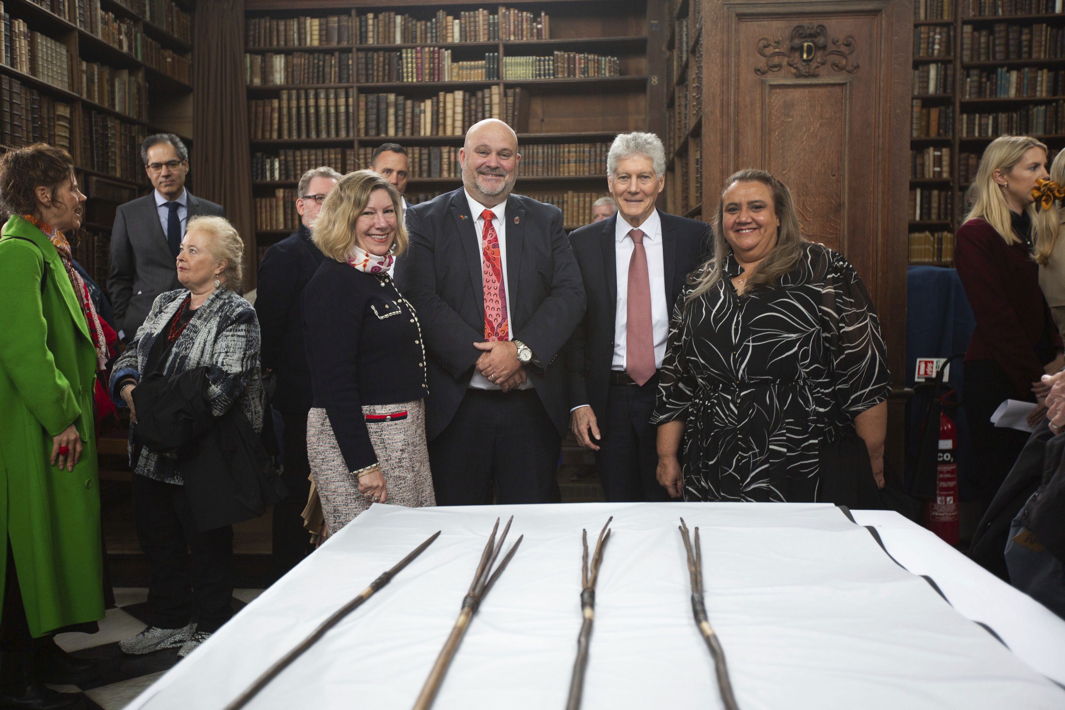 Elisabeth Bowes, Leonard Hill, Stephen Smith and Noeleen Timbery with four Aboriginal spears that were brought to England by Captain James Cook more than 250 years ago and have now been repatriated to Australia in a ceremony at Trinity College in Cambridge, Tuesday April 23, 2024. 