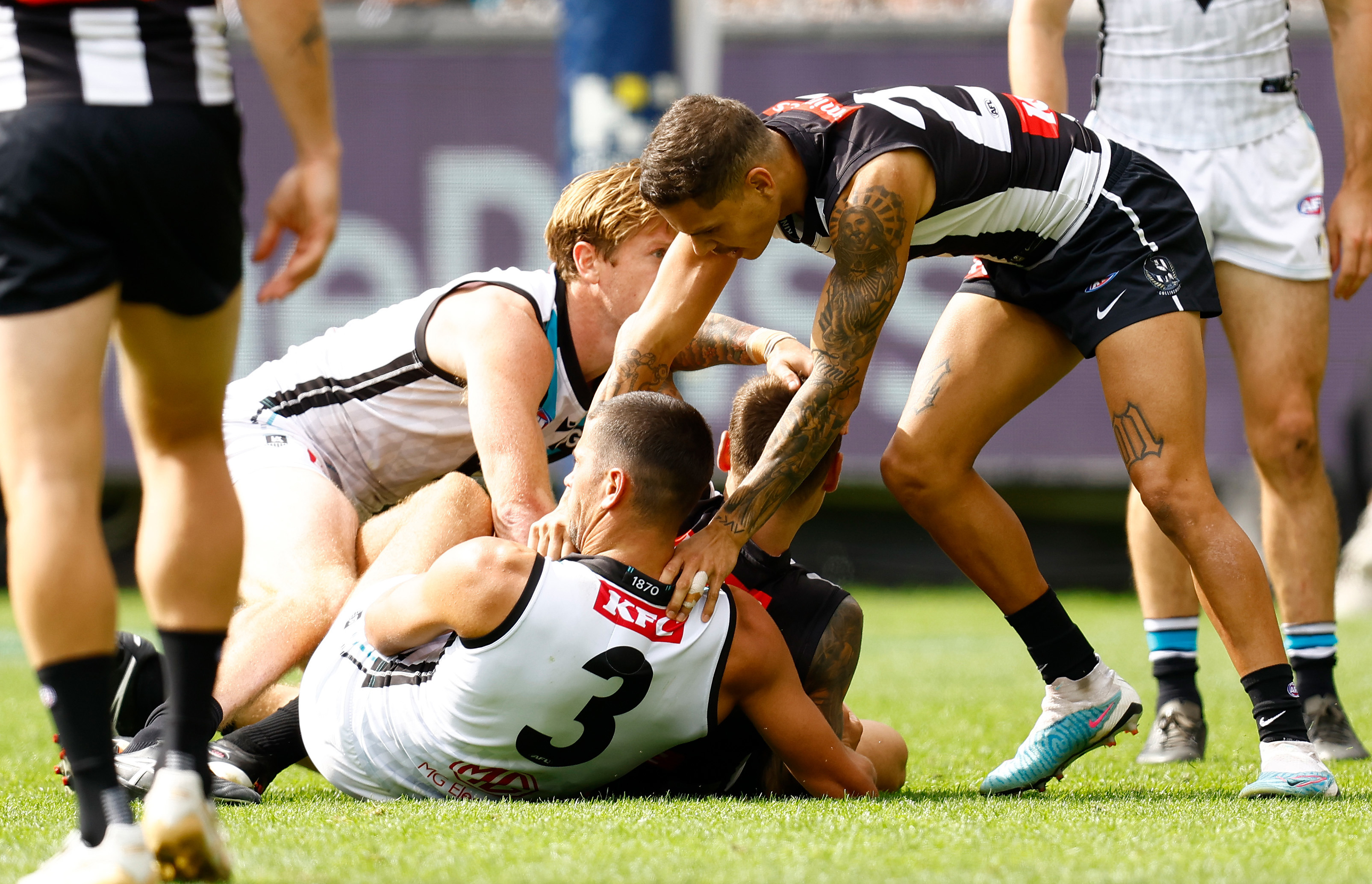 MELBOURNE, AUSTRALIA - MARCH 25: Jamie Elliott of the Magpies holds his head after a tackle by Ryan Burton of the Power during the 2023 AFL Round 02 match between the Collingwood Magpies and the Port Adelaide Power at the Melbourne Cricket Ground on March 25, 2023 in Melbourne, Australia. (Photo by Michael Willson/AFL Photos)