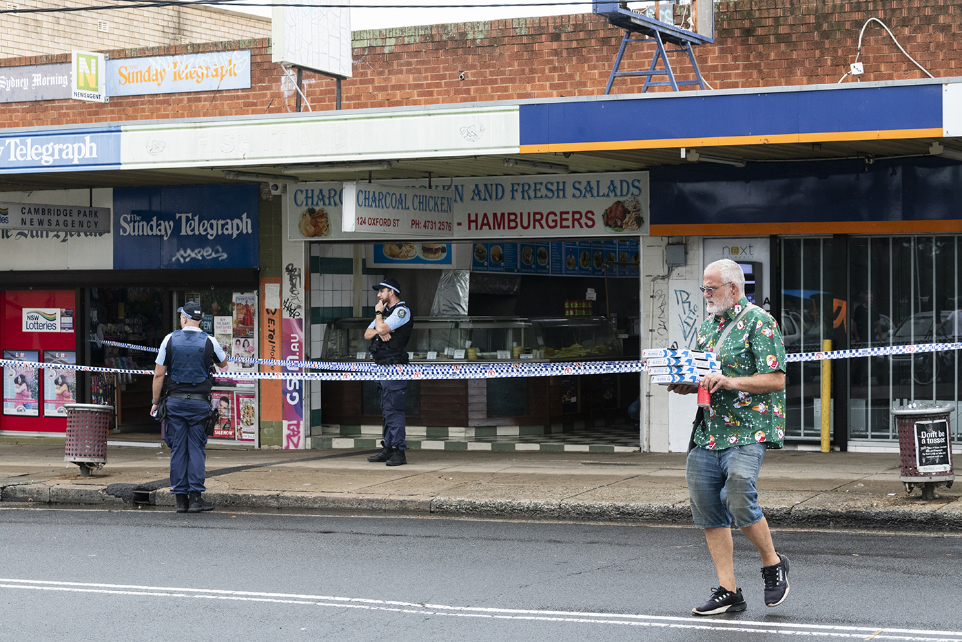 Two bodies have been found on Oxford St, Cambridge. Possible family members of the victims are escorted by the police.November 30, 2024. Photo: Rhett Wyman / SMH