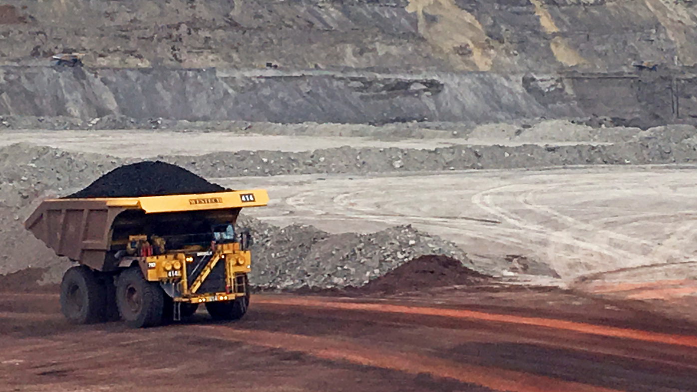 A dump truck hauls coal at an unspecified mine.