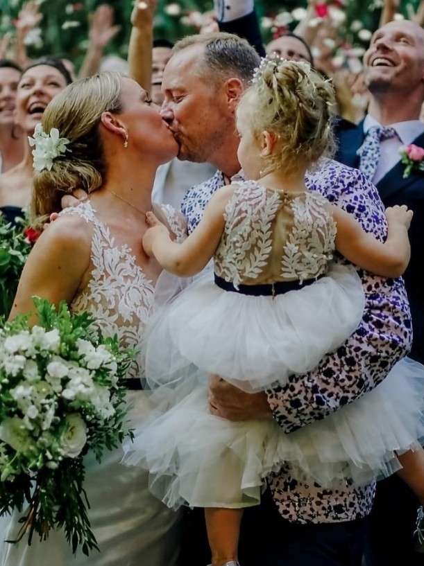 Mel Schilling with husband Gareth Brisbane and daughter Maddie on their wedding day.