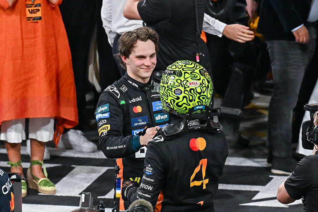 British driver Lando Norris (R) embraces teammate Oscar Piastri (L).