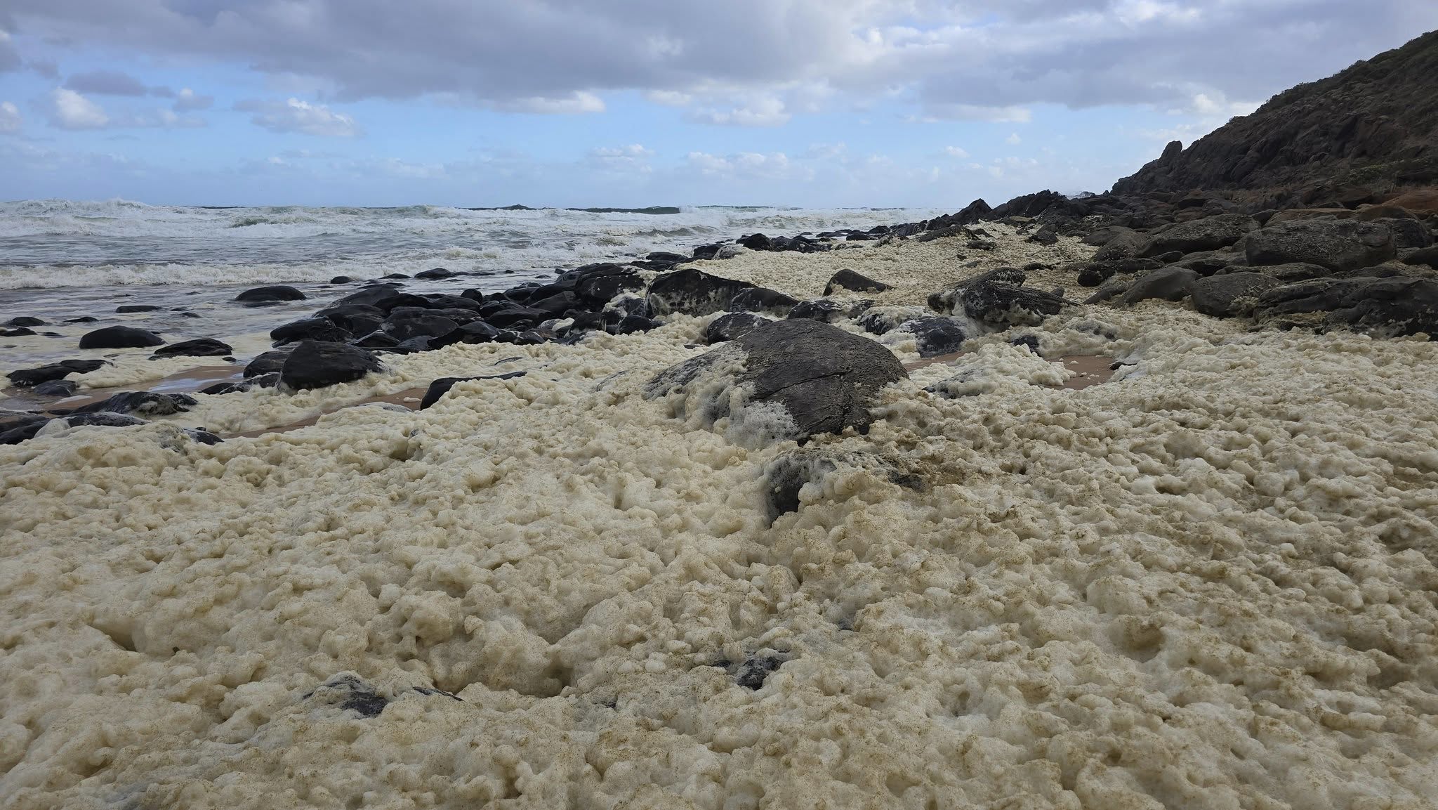 A multi-agency investigation is underway after masses of yellow foam washed up on a popular South Australian beach, leaving surfers feeling sick and infected. ﻿