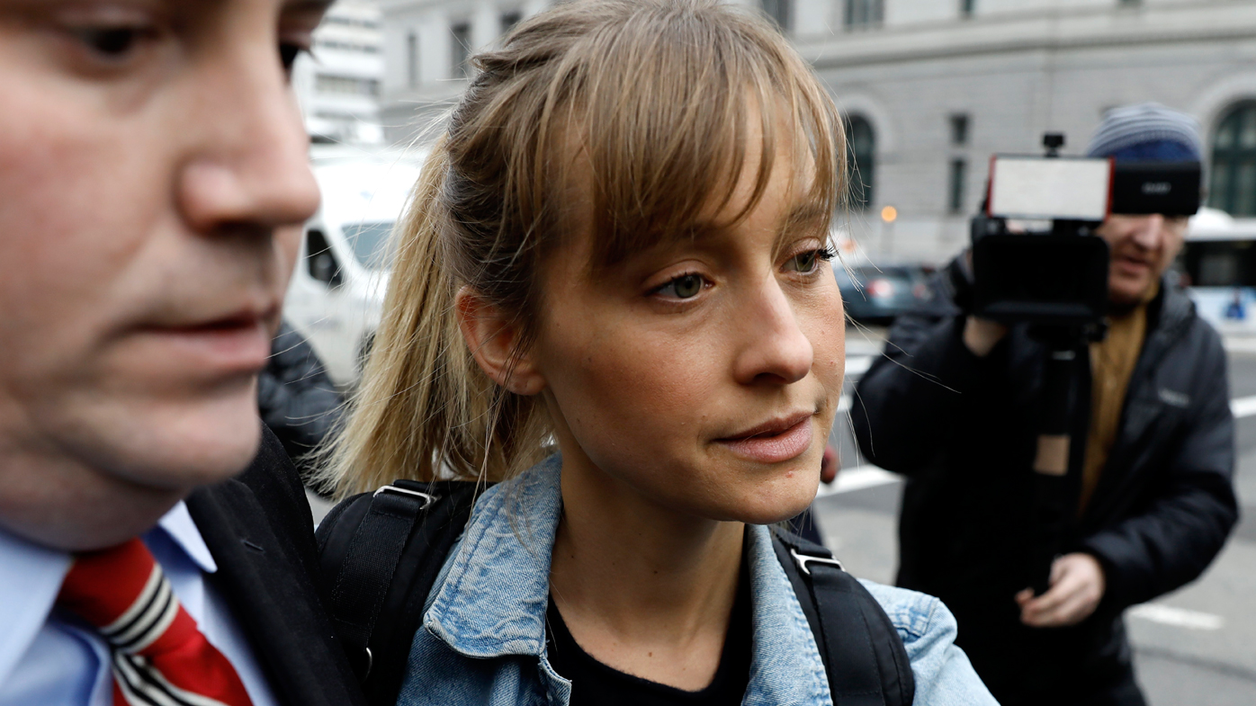 Actress Allison Mack exits federal court in Brooklyn, New York, after her arrest on charges of recruiting women into a sex trafficking operation.