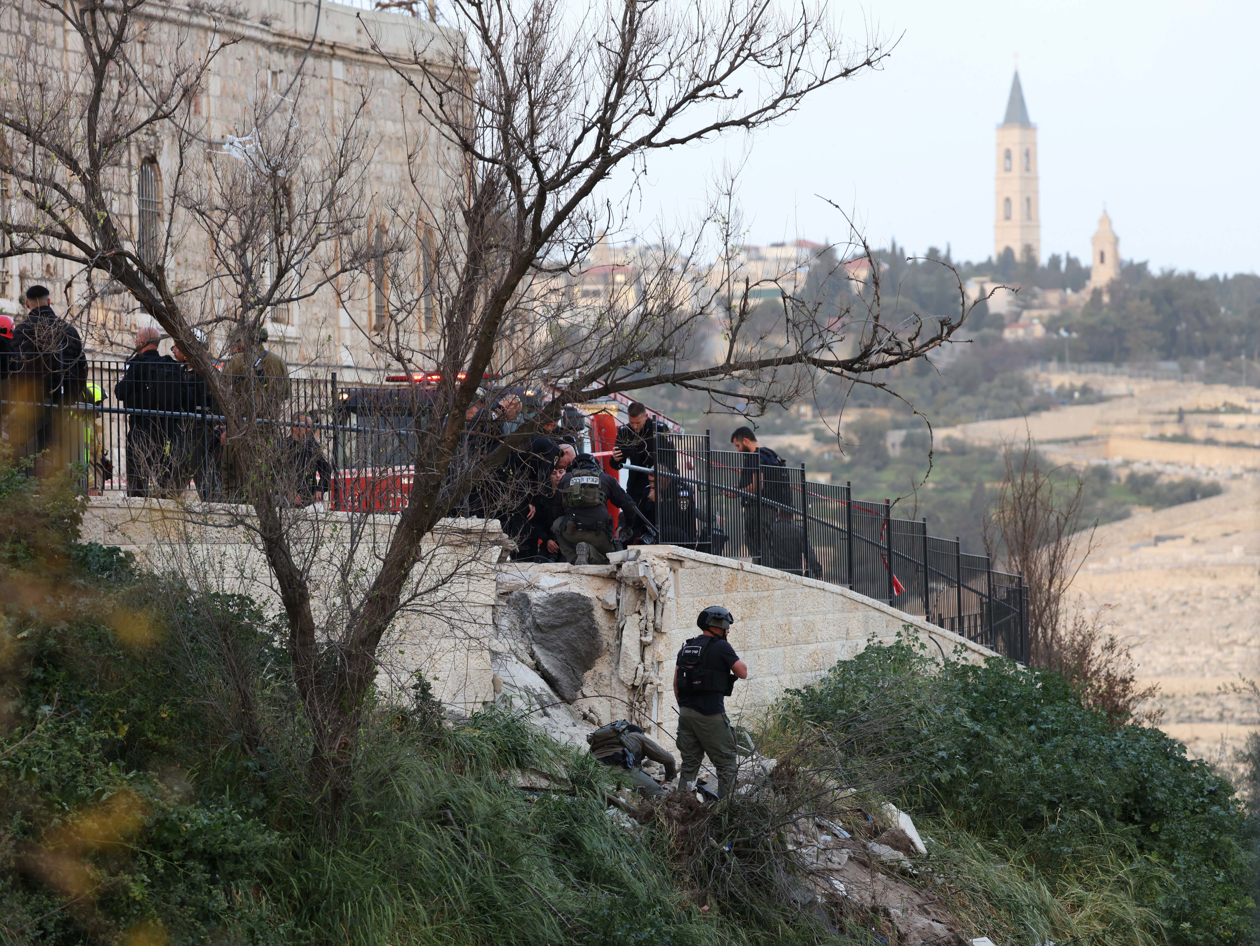 First responders inspect damage where an Iranian missile fragment landed  in the Old City of Jerusalem.