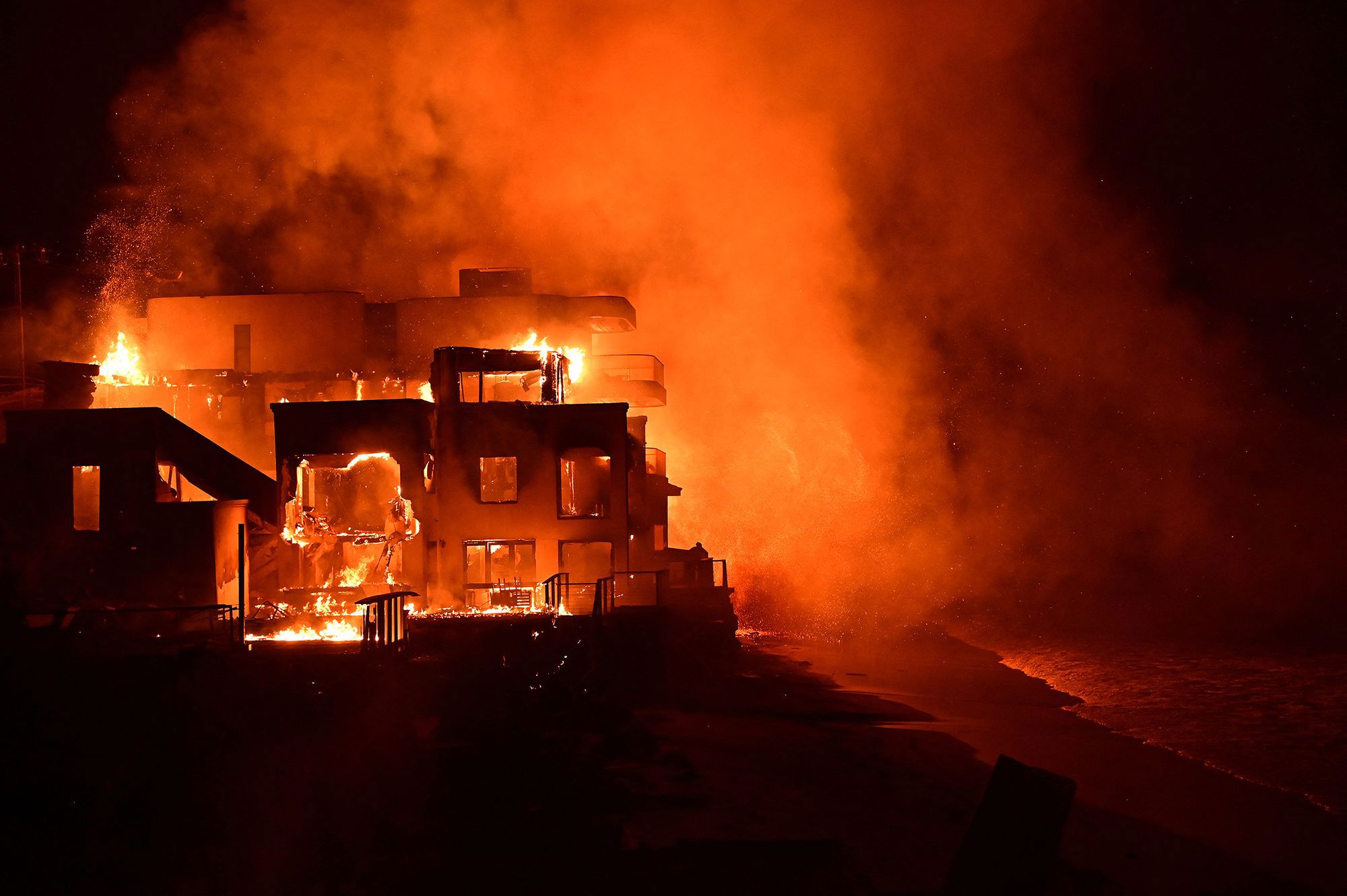 A beach house is engulfed in flames as the Palisades Fire burns along Pacific Coast Highway in Malibu, California on January 8.