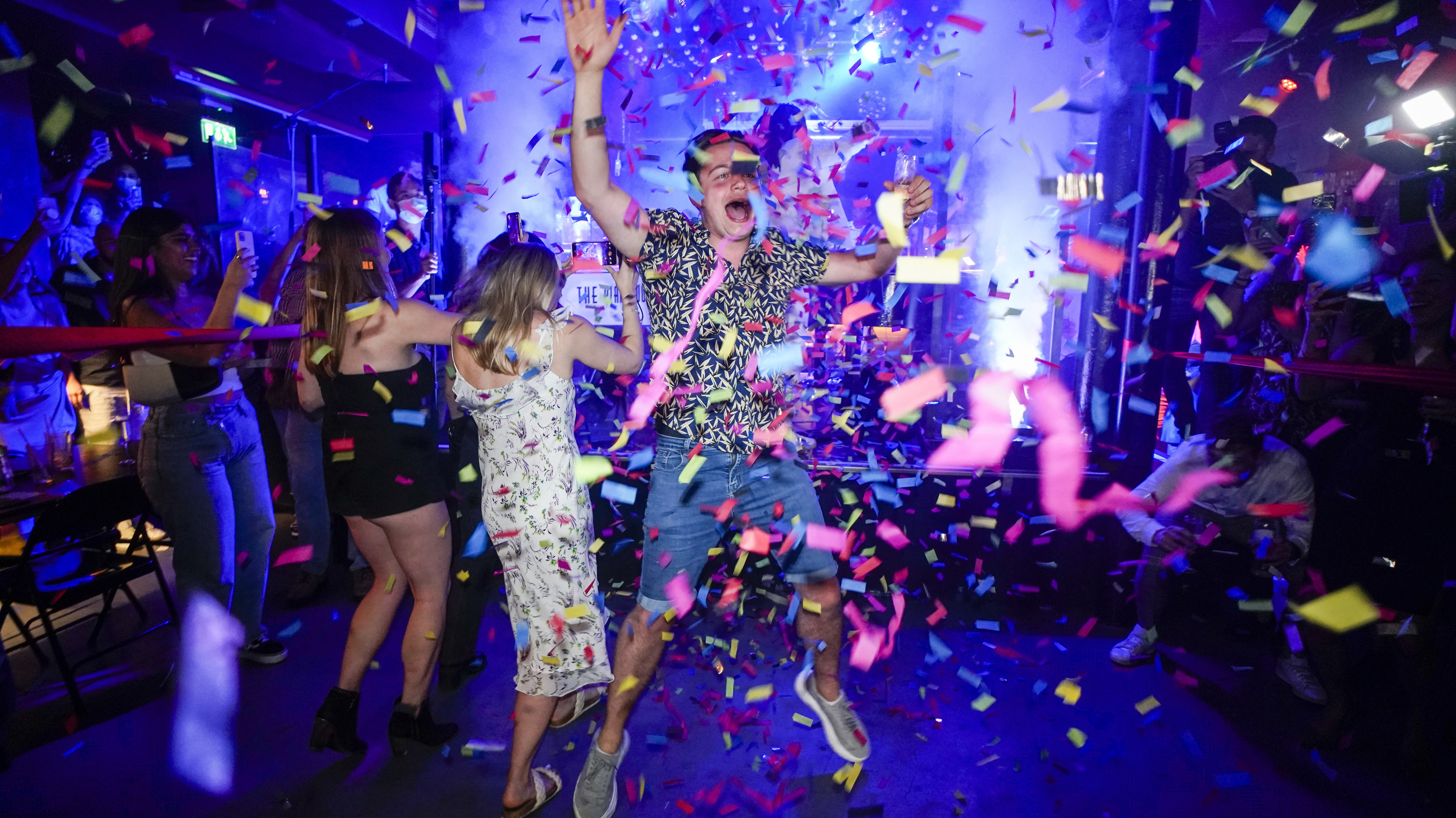 A man jumps on the dance floor shortly after the reopening of The Piano Works Farringdon in London, as England's country's nightclubs reopened. 