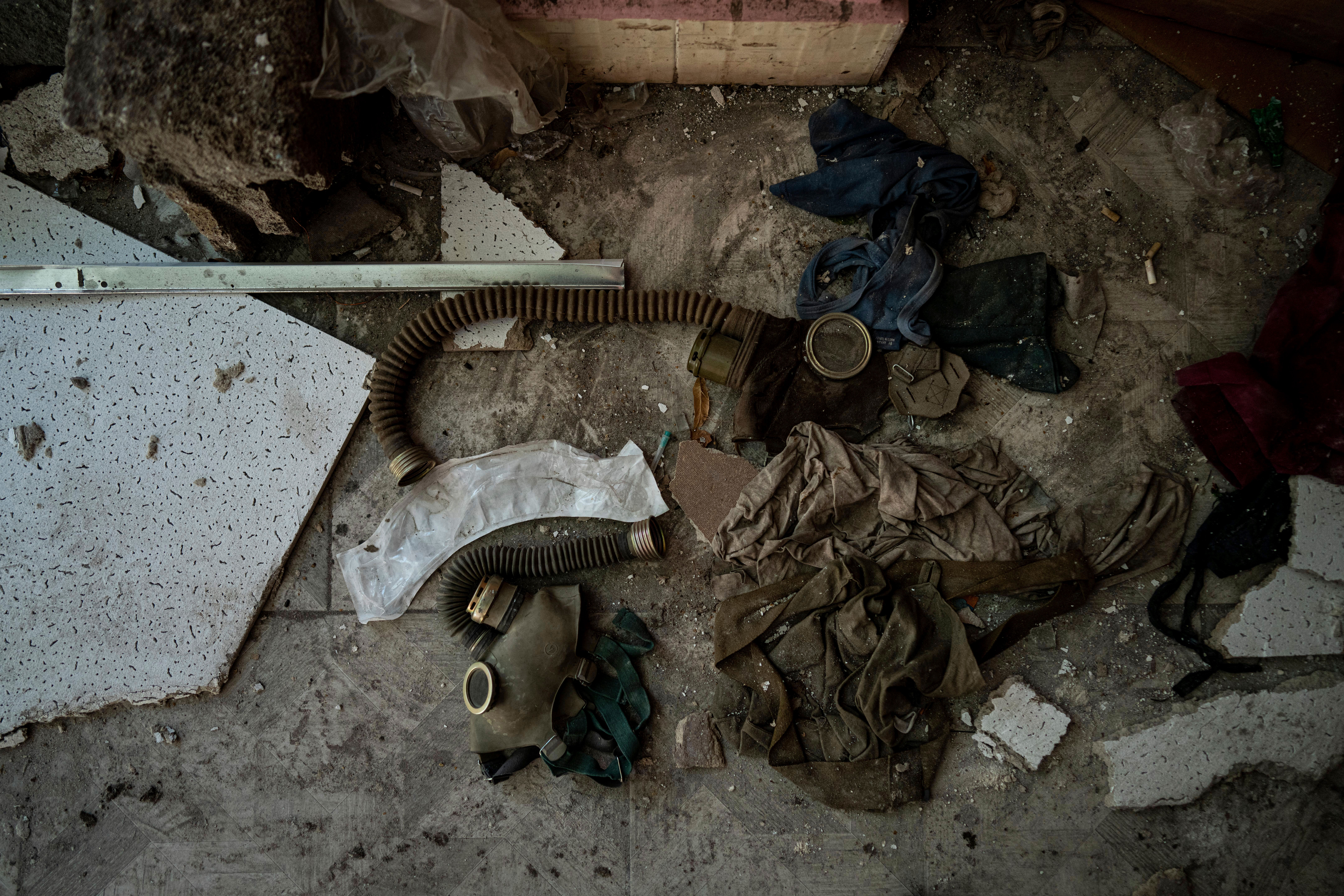 Soviet-era gas masks lie on the floor at the corridor of School No. 2 which was used as a Russian military base and torture site in the recently retaken town of Izium