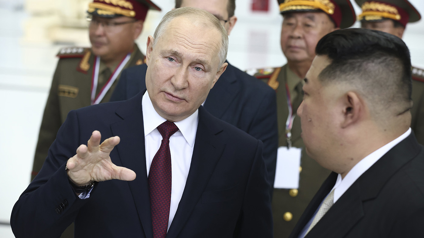 Putin and Kim speak at a rocket assembly hangar during their meeting.