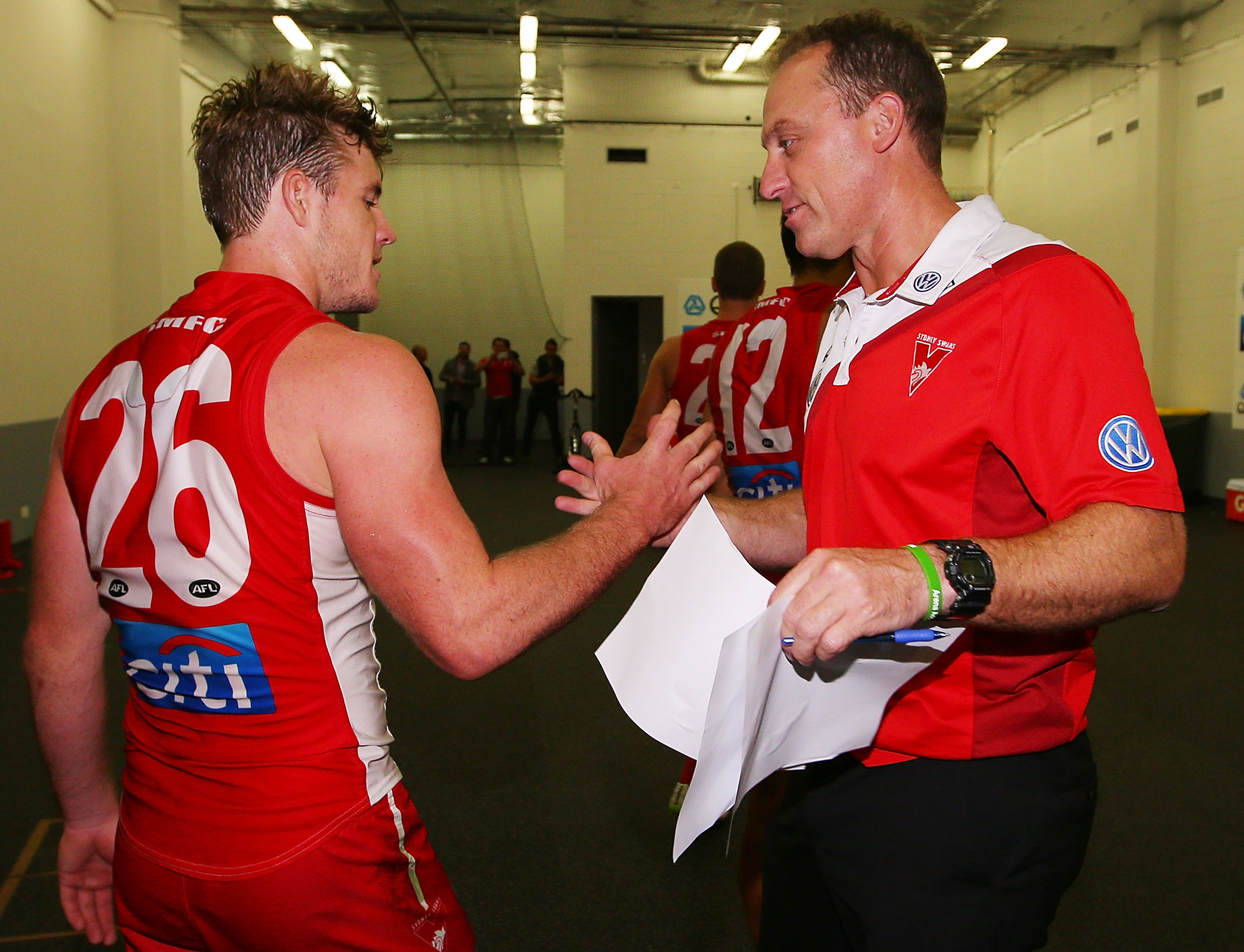 Swans head coach John Longmire celebrates a win with Luke Parker.