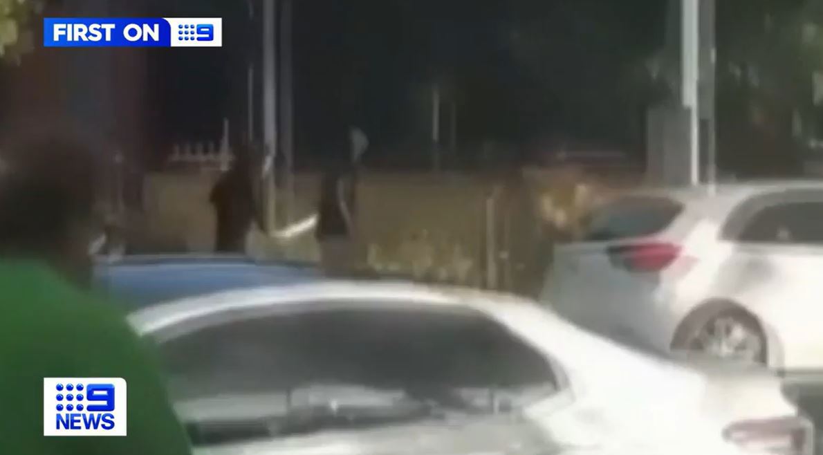 A teenage boy has escaped injury after two people allegedly chased him with machetes outside a school in Melbourne's west.

