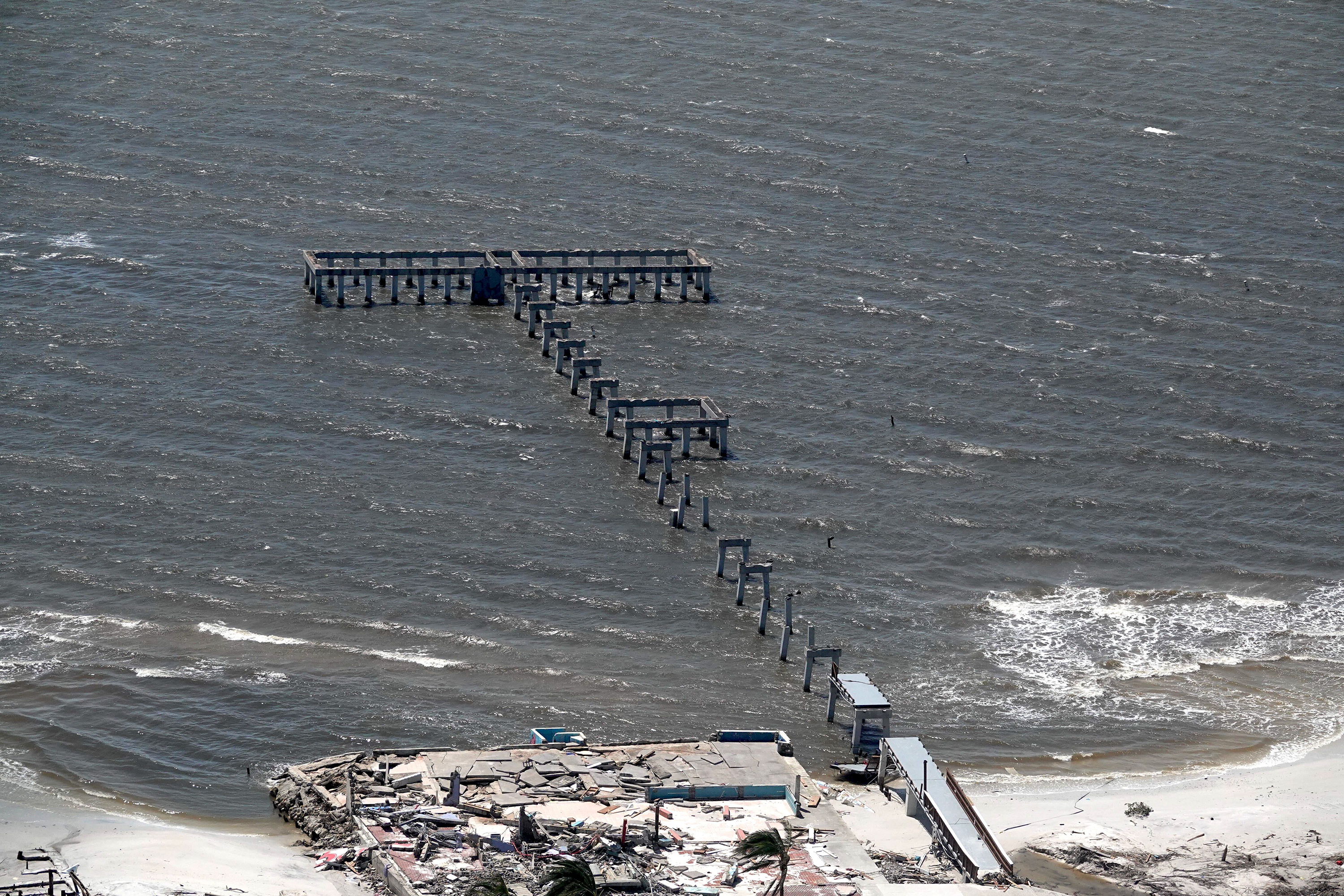 This aerial photo shows the damaged Fort Myers Fishing Pier in the aftermath of Hurricane Ian on Thursday, Sept. 29, 2022 in  Fort Myers Beach, Fla.  (Joe Cavaretta/South Florida Sun-Sentinel via AP)