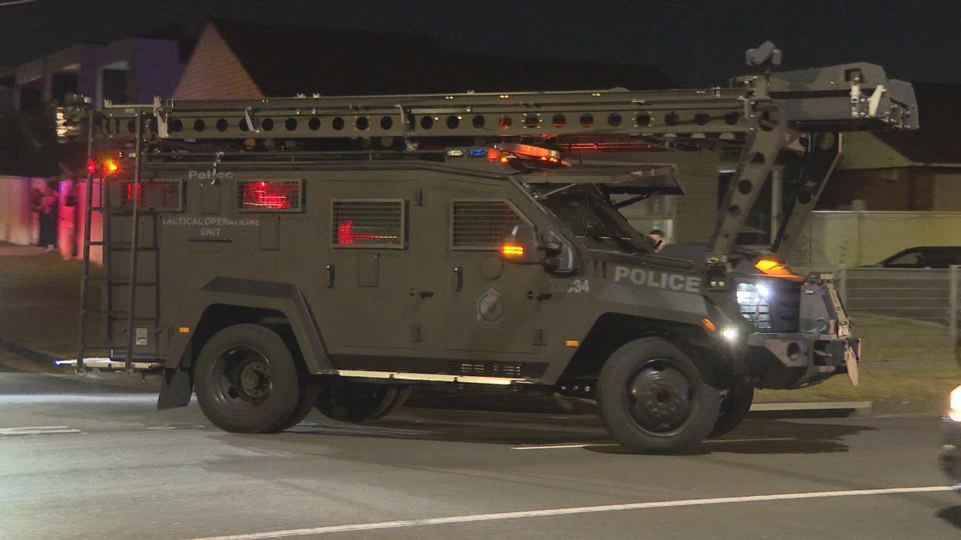 Tactical police surround home in Sydney