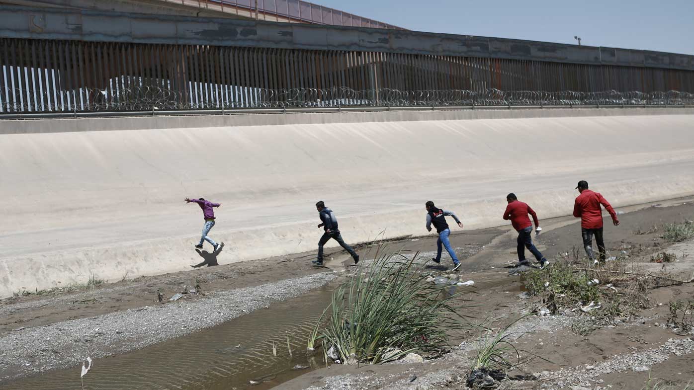 Migrants rush across the border between Juarez, Mexico, and El Paso, USA.