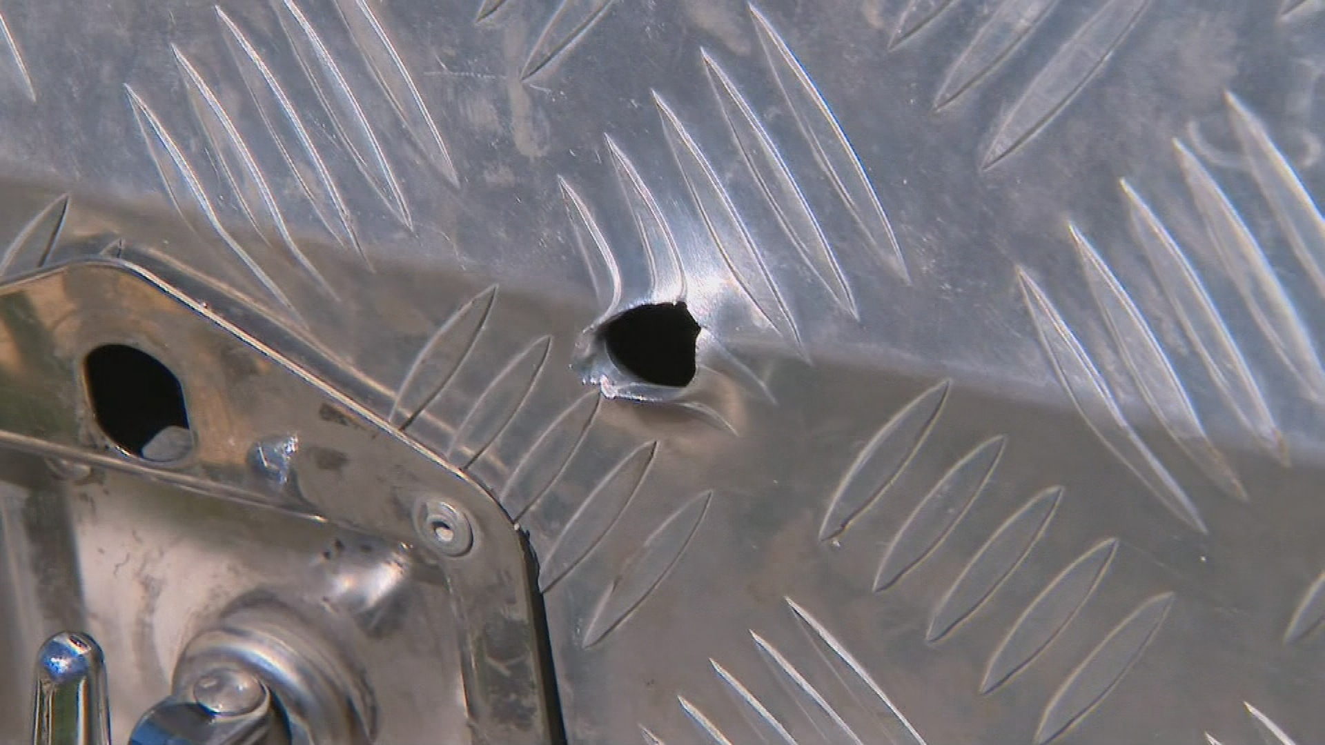 Bullet holes were left in cars, walls and doors.