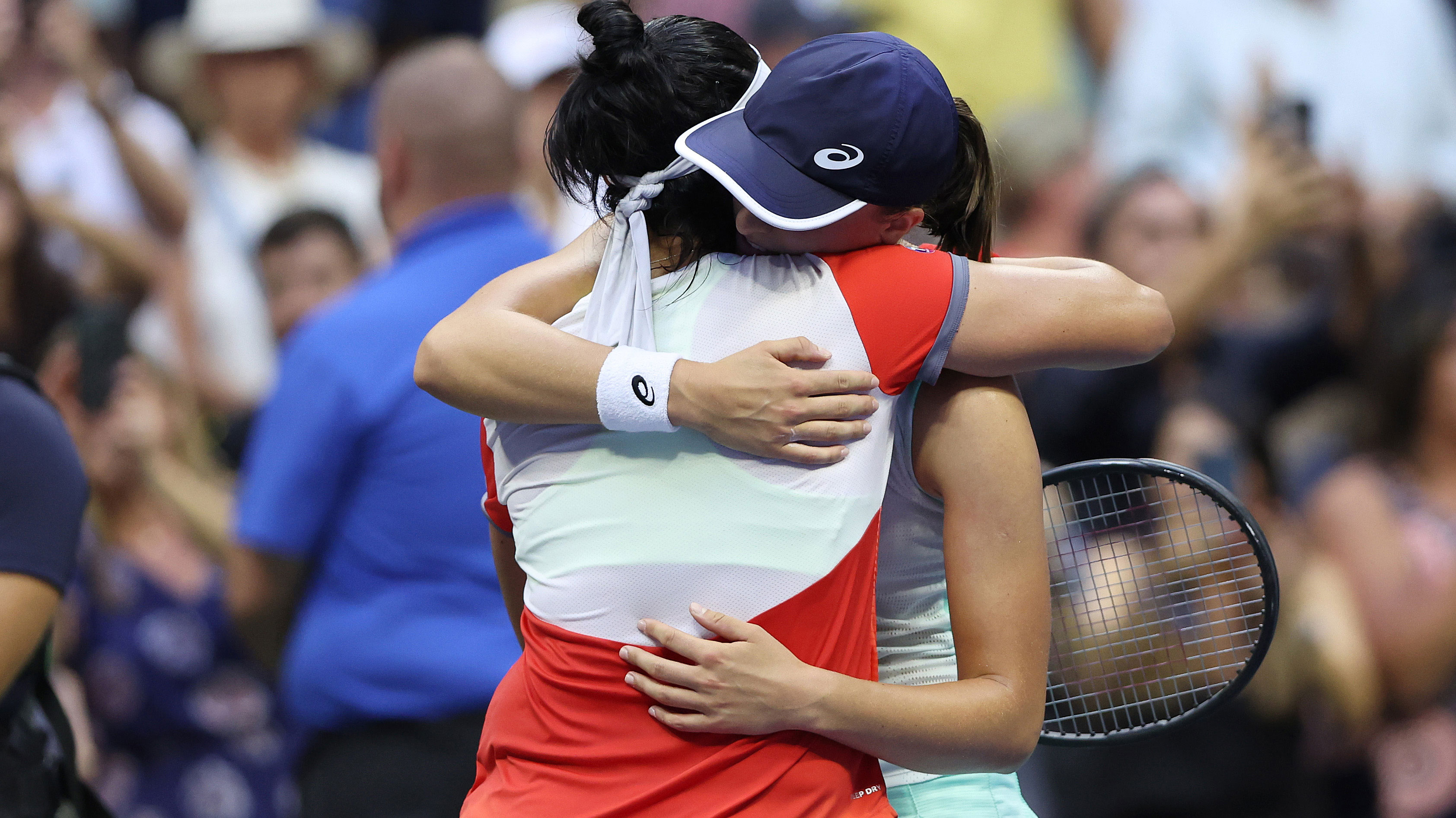 Iga Swiatek of Poland hugs Ons Jabeur of Tunisia after the world No.1 hung on to win the US Open in straight sets.