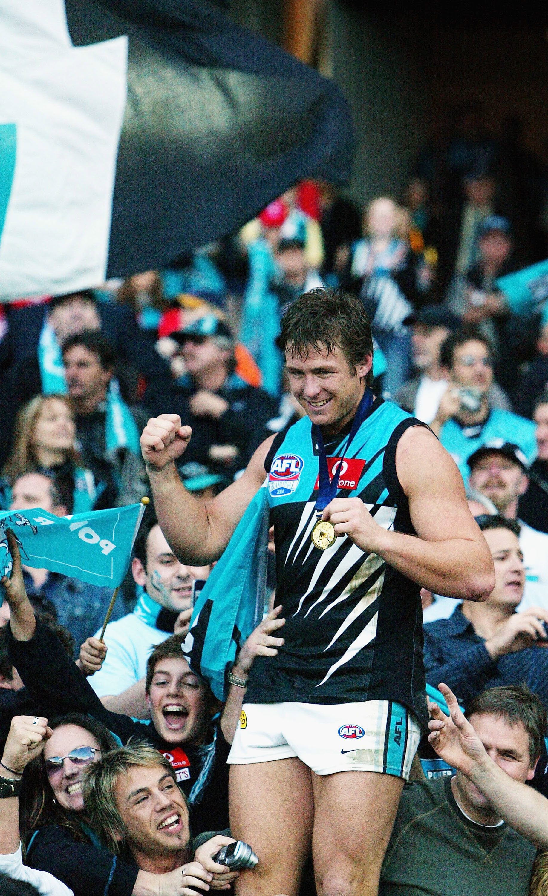 Stuart Dew celebrates Port Adelaide's 2004 premiership win over Brisbane at the MCG.