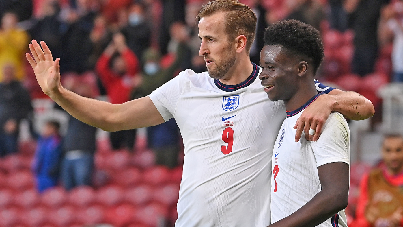 Bukayo Saka (r) of England is congratulated on scoring the opening goal by Harry Kane 
