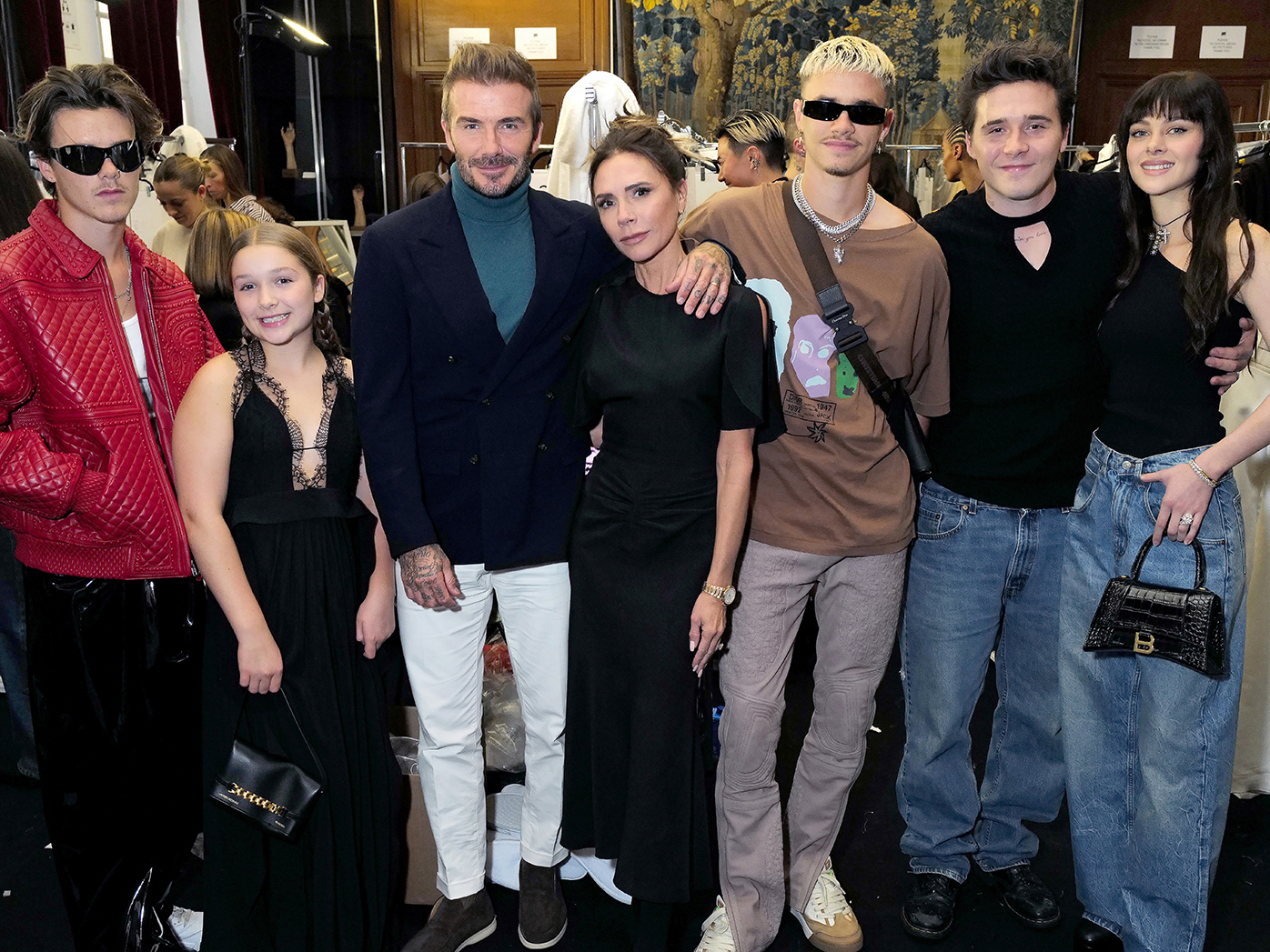 The Beckham family: Cruz Beckham, Harper Beckham, David Beckham, Victoria Beckham, Romeo Beckham,  Brooklyn Beckham and Nicola Peltz Beckham at the Victoria Beckham Spring/summer 2023 Runway show on September 30, 2022 in Paris, France. 