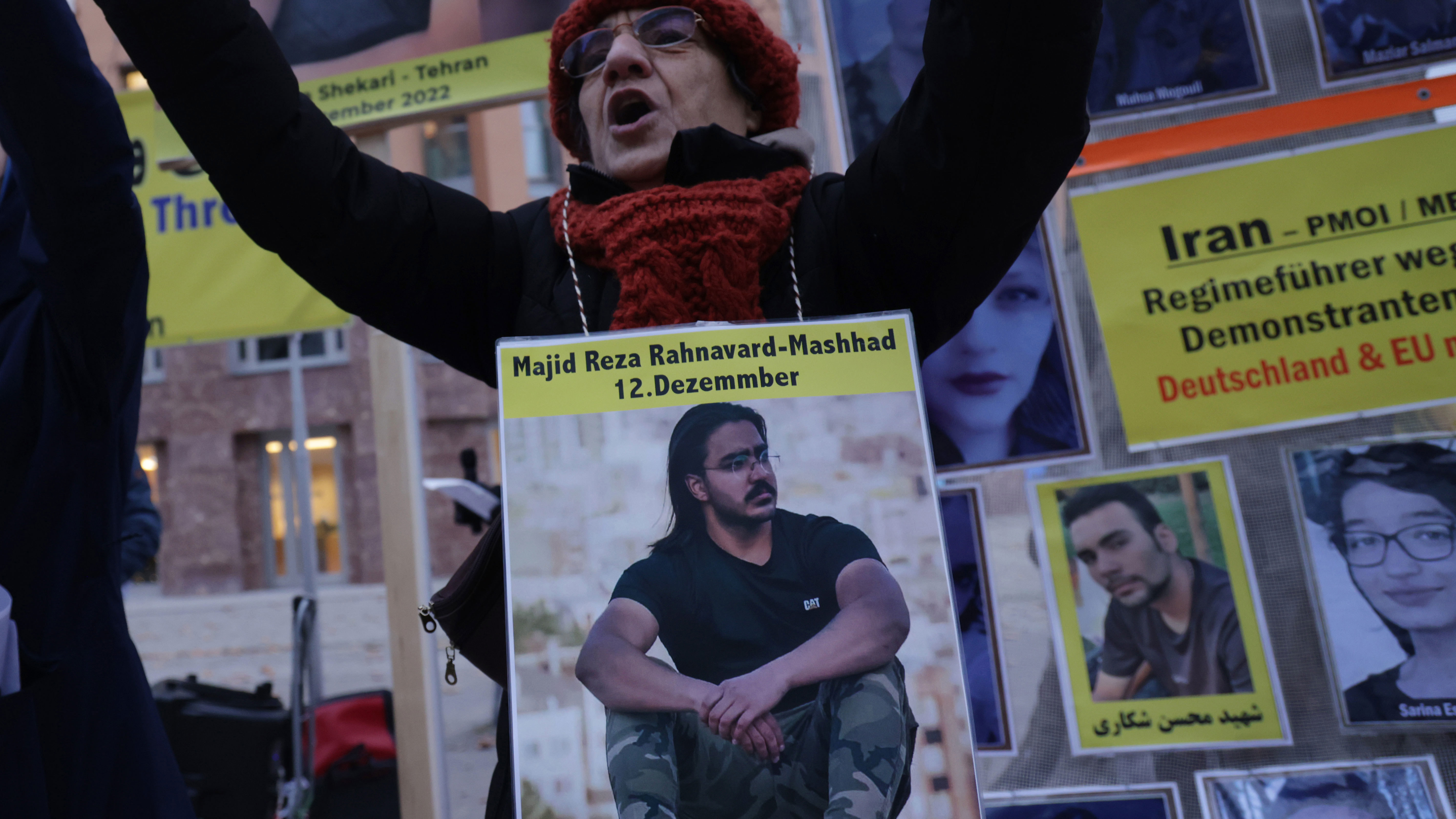 Protesters wear portraits of Majid Reza Rahnavard, 23, and Mohsen Shekari, 23, both of whom were recently executed by Iranian authorities, during a demonstration by supporters of the National Council of Resistance of Iran outside the German Foreign Ministry on December 12, 2022 in Berlin, Germany