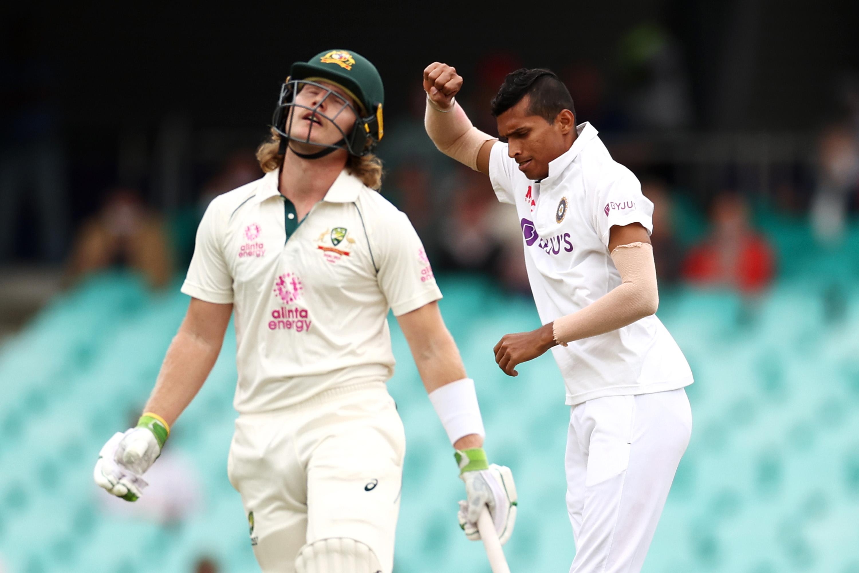 Navdeep Saini of India celebrates dismissing Will Pucovski of Australia.