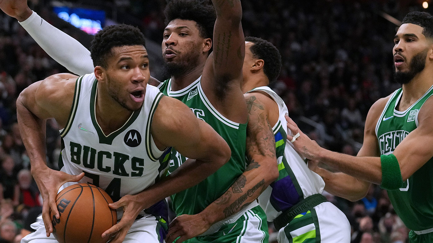 Giannis Antetokounmpo #34 of the Milwaukee Bucks dribbles the ball against Marcus Smart #36 of the Boston Celtics 