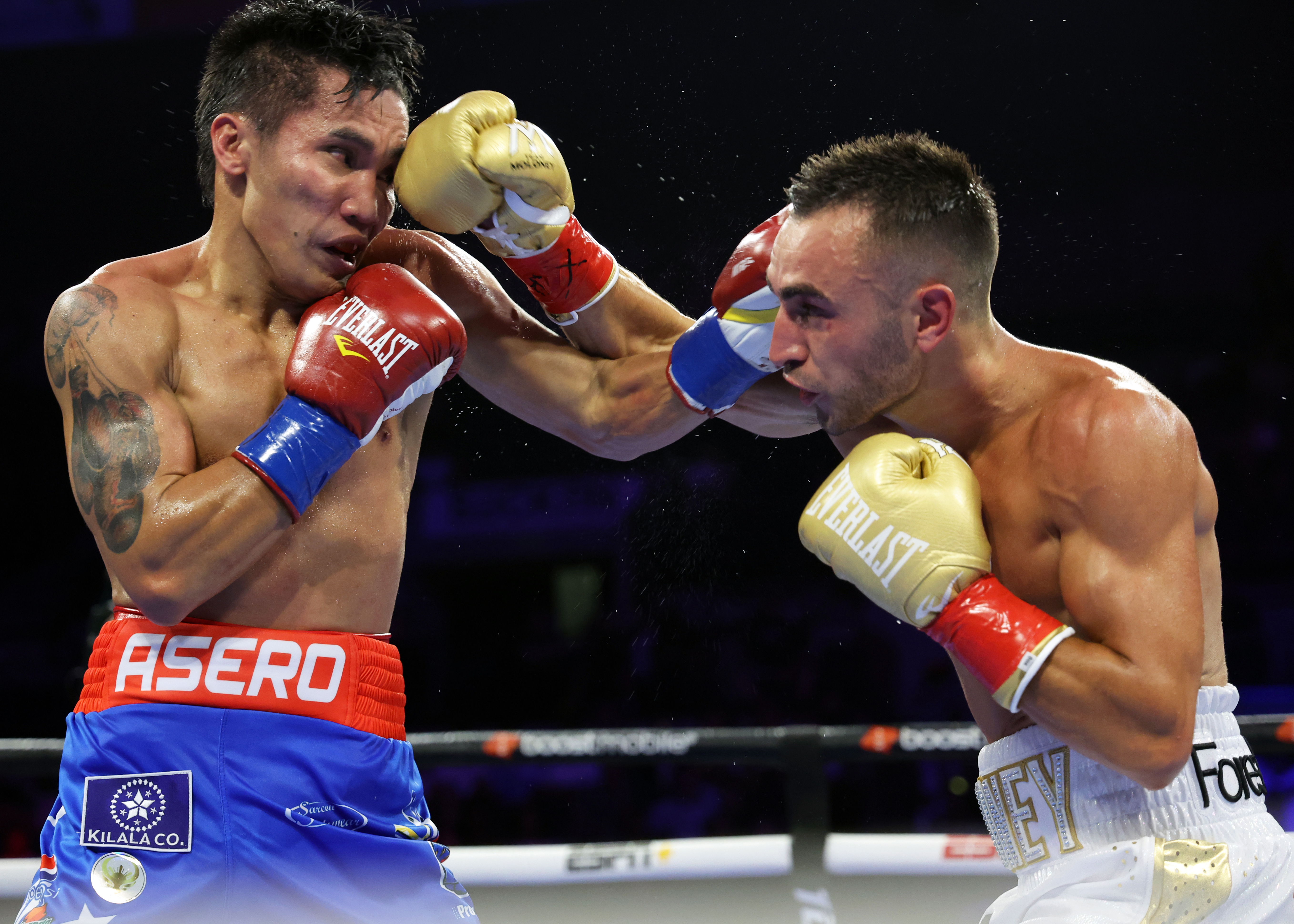Vincent Astrolabio (left) and Jason Moloney exchange punches during their WBO bantamweight championship fight.
